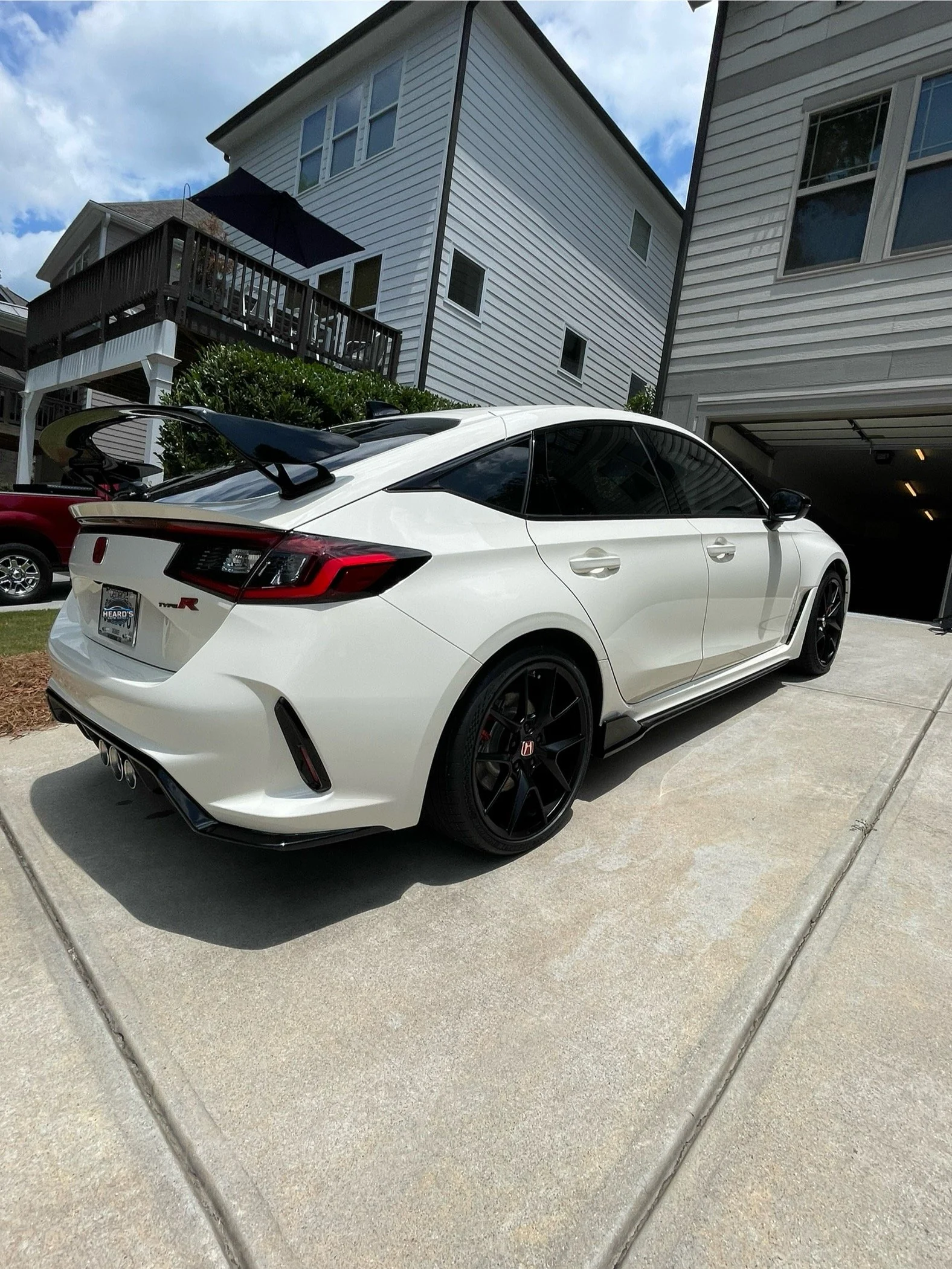 Deep gloss ceramic coating applied to a white Honda Type R sedan in Woodstock in the Towne Lake area, providing long-lasting protection and shine.