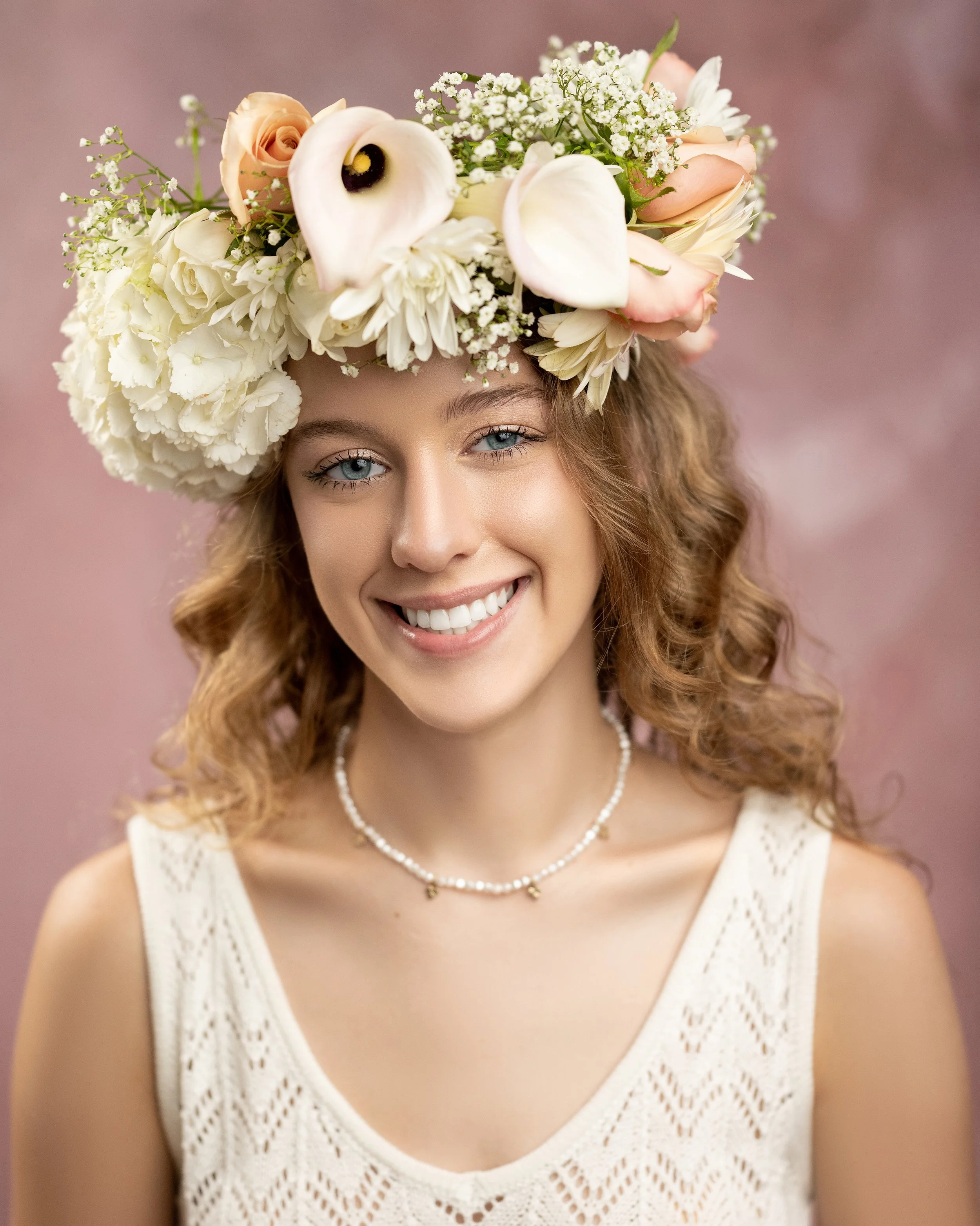 An heirloom portrait by Heidi Knight of a teen girl ,and younger sister, wearing an elaborate flower crown.