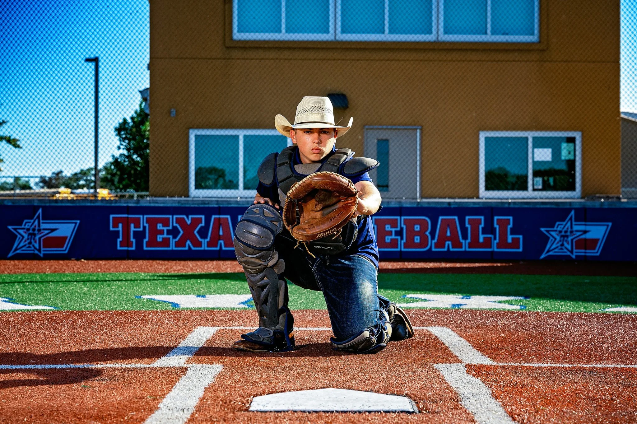 the base photograph by Heidi Knight of a high school senior boy with a cowboy and baseball theme