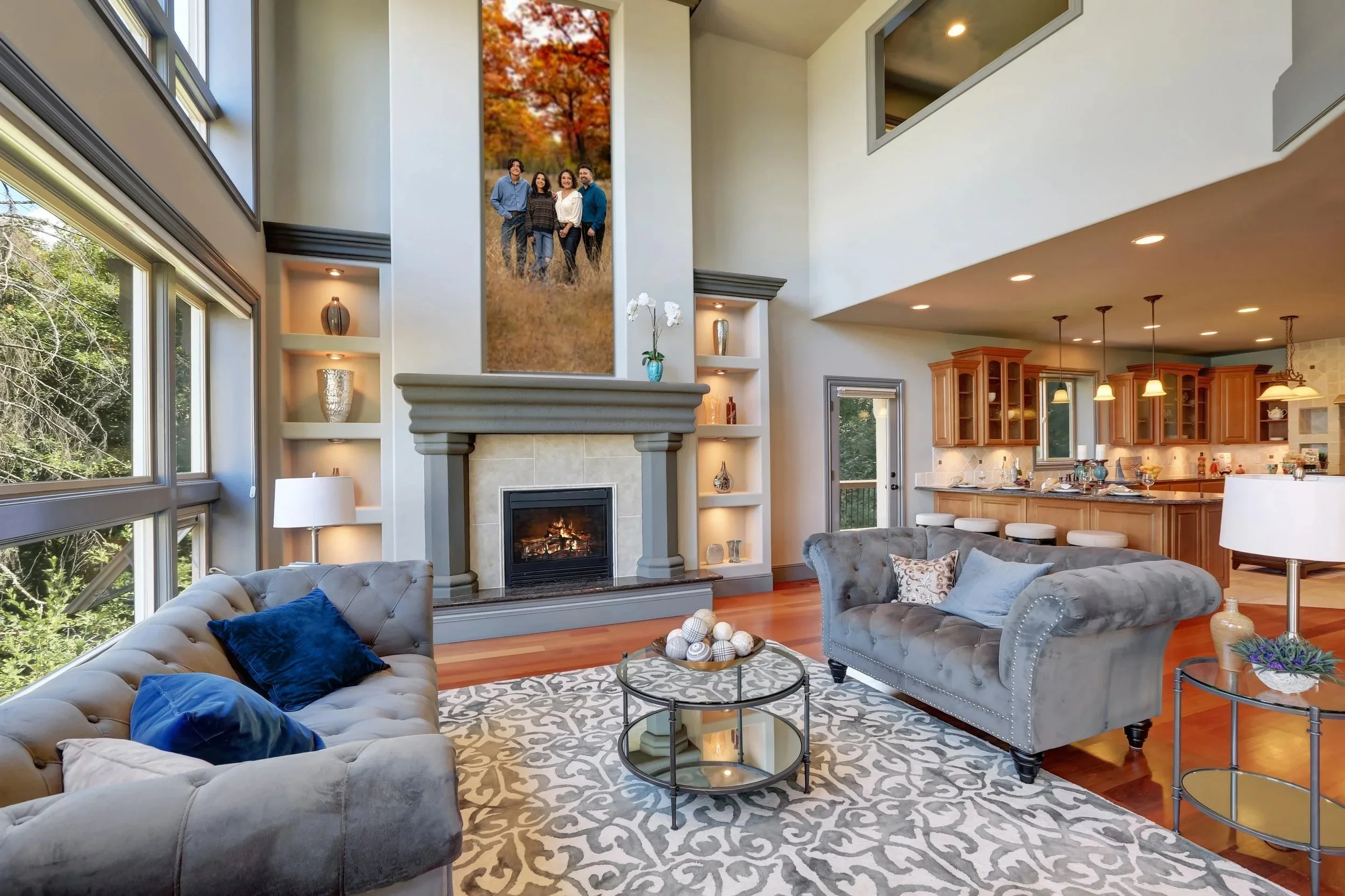 A huge family portrait above a large 2 story fireplace by Heidi Knight Fine Art.