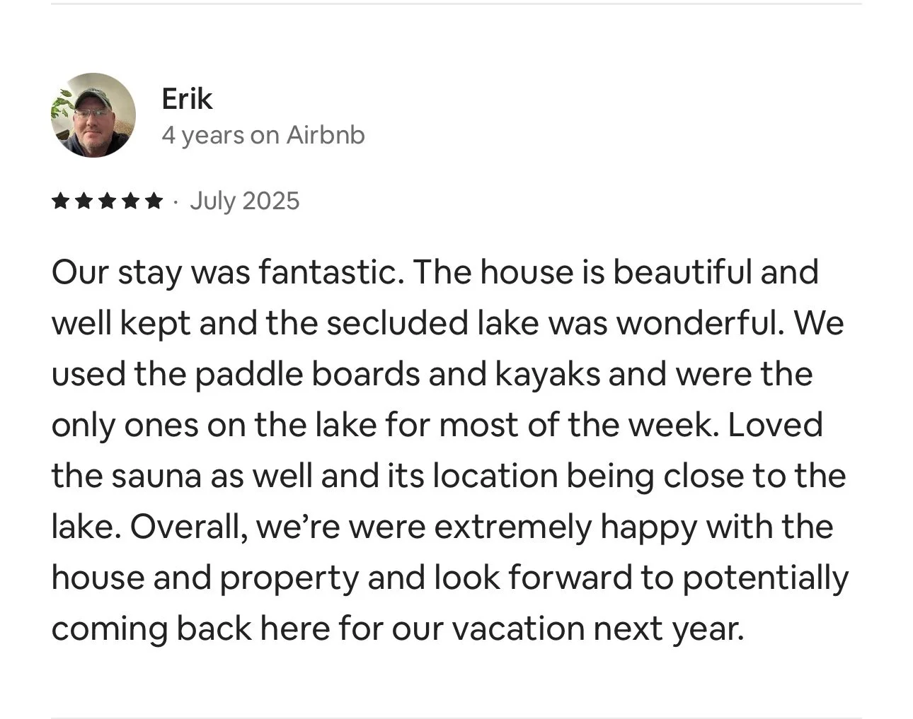 Screenshot of a positive Airbnb review by Erik, dated July 2025, praising a house with a lake, paddle boards, kayaks, and a sauna.