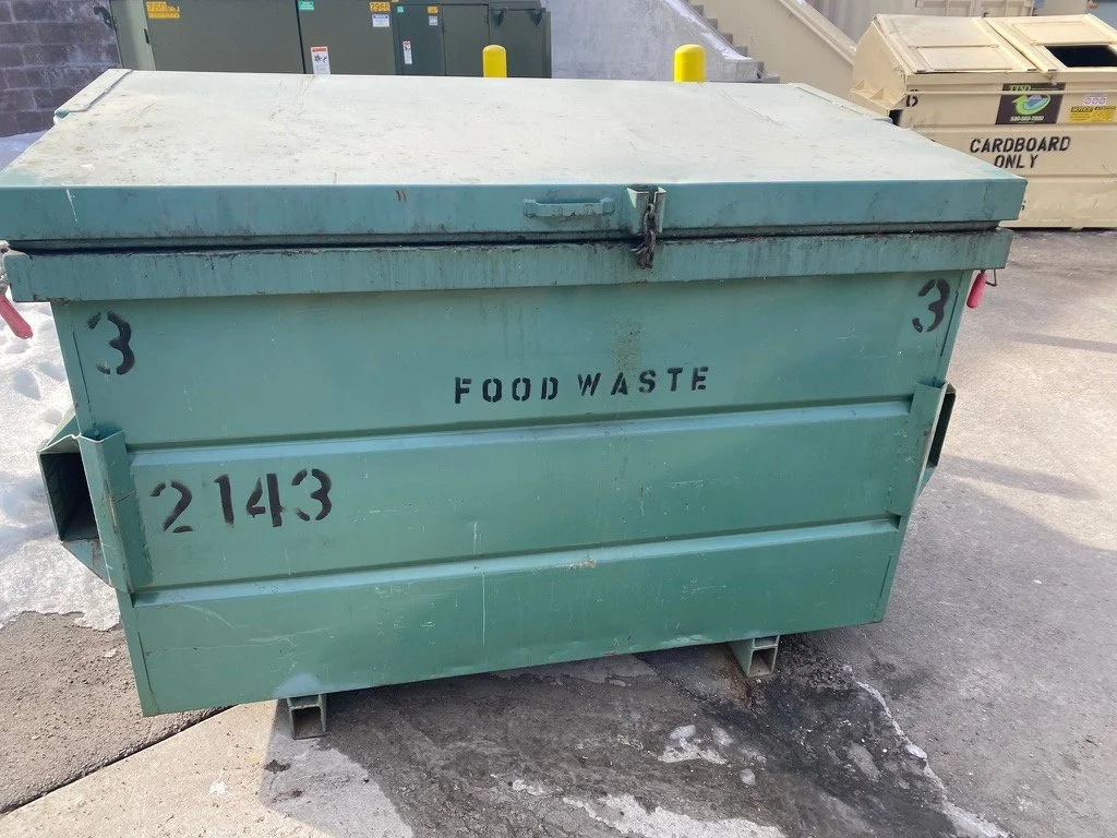 Green food waste dumpster photographed during a commercial waste audit