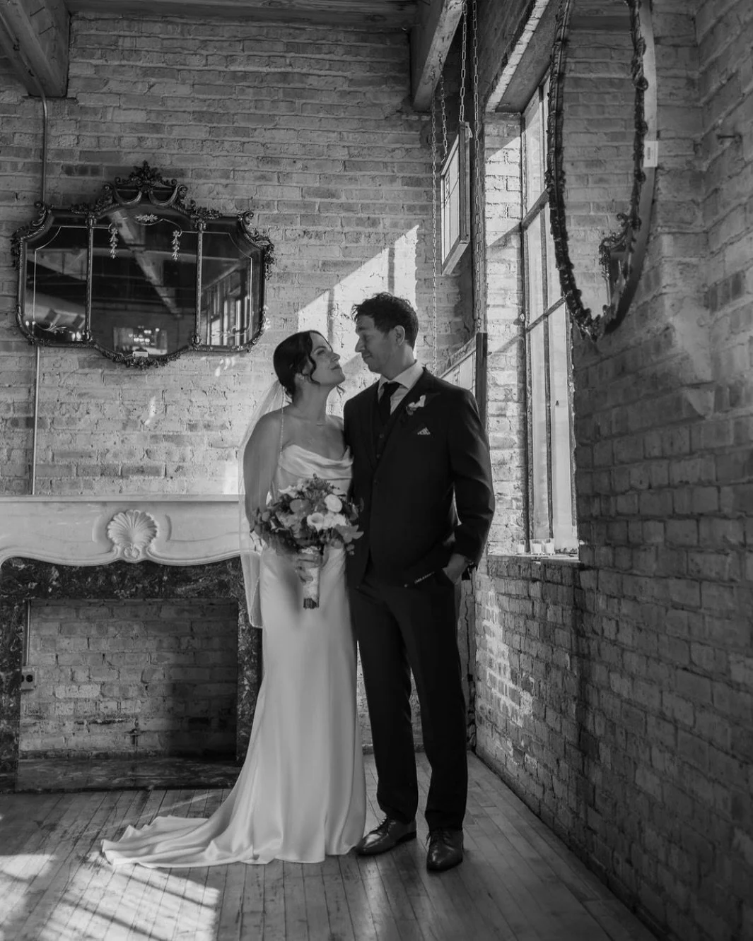Kat + Andy a year ago in B&amp;W 🖤🤍

Happy belated first wedding anniversary you two!! 🥂 
It was such a joy to watch you get married 🤭🥹✨

planning: @shh.events | @meghanstegemann 
venue: @salvageoneevents 
catering: @heartyboys 
liquor: @garfiel