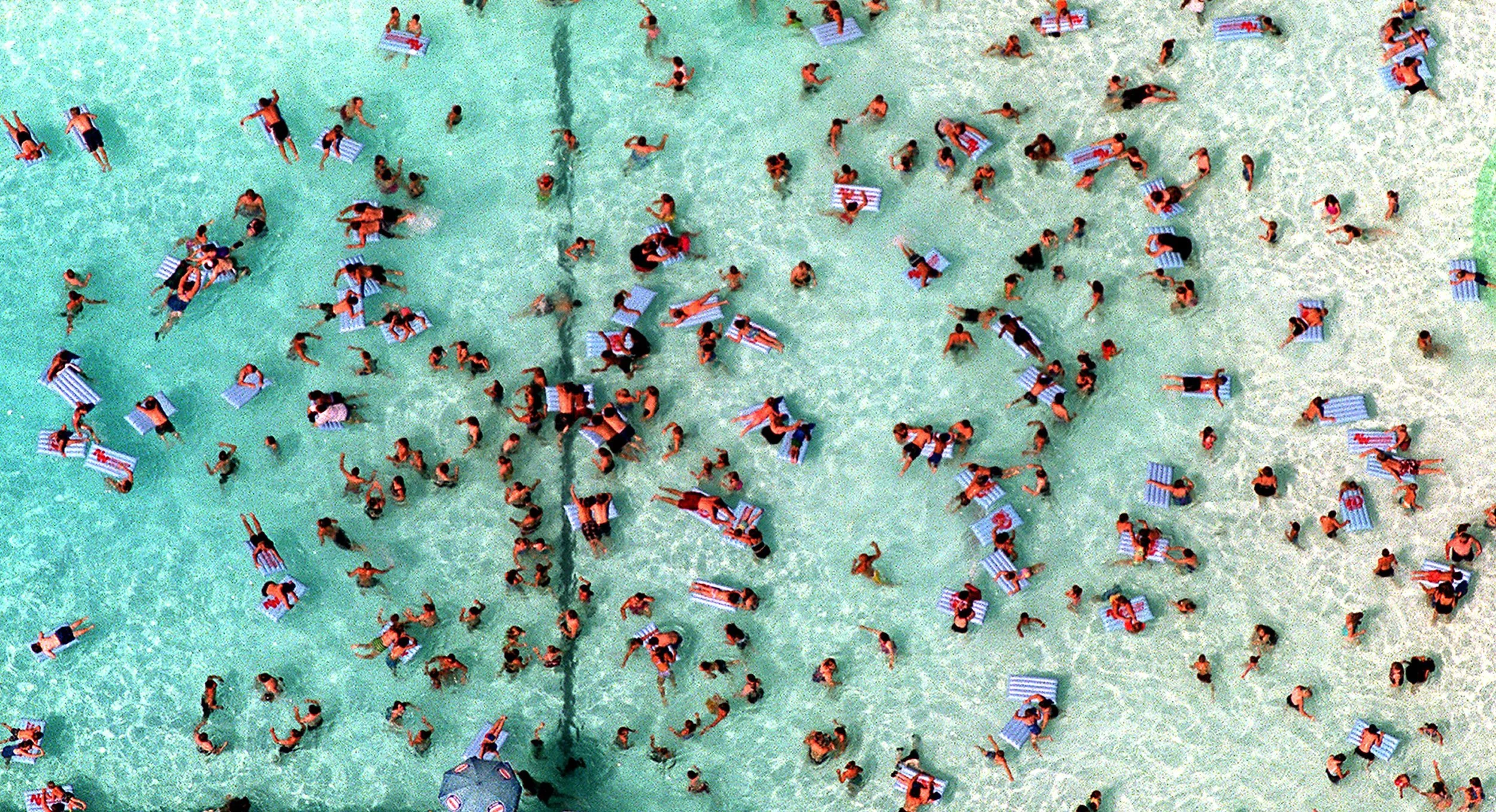 Looking down on sun lovers lounging in the pool at Wild Waves Water Park, soaking up the mid-summer rays. ©Thomas James Hurst/The Seattle Times