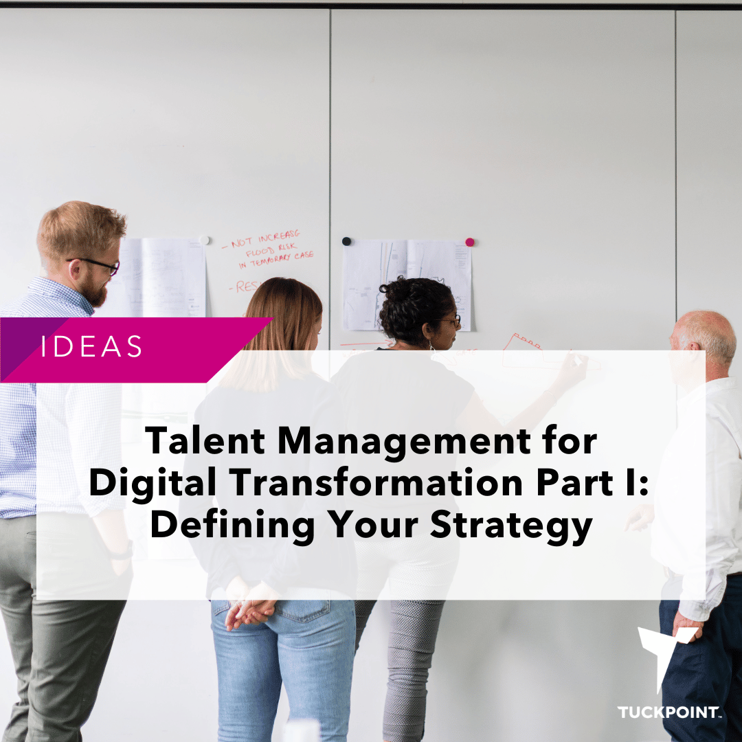 Team of four people working at a whiteboard to discuss Talent Management for Digital Transformation Part I: Defining Your Strategy