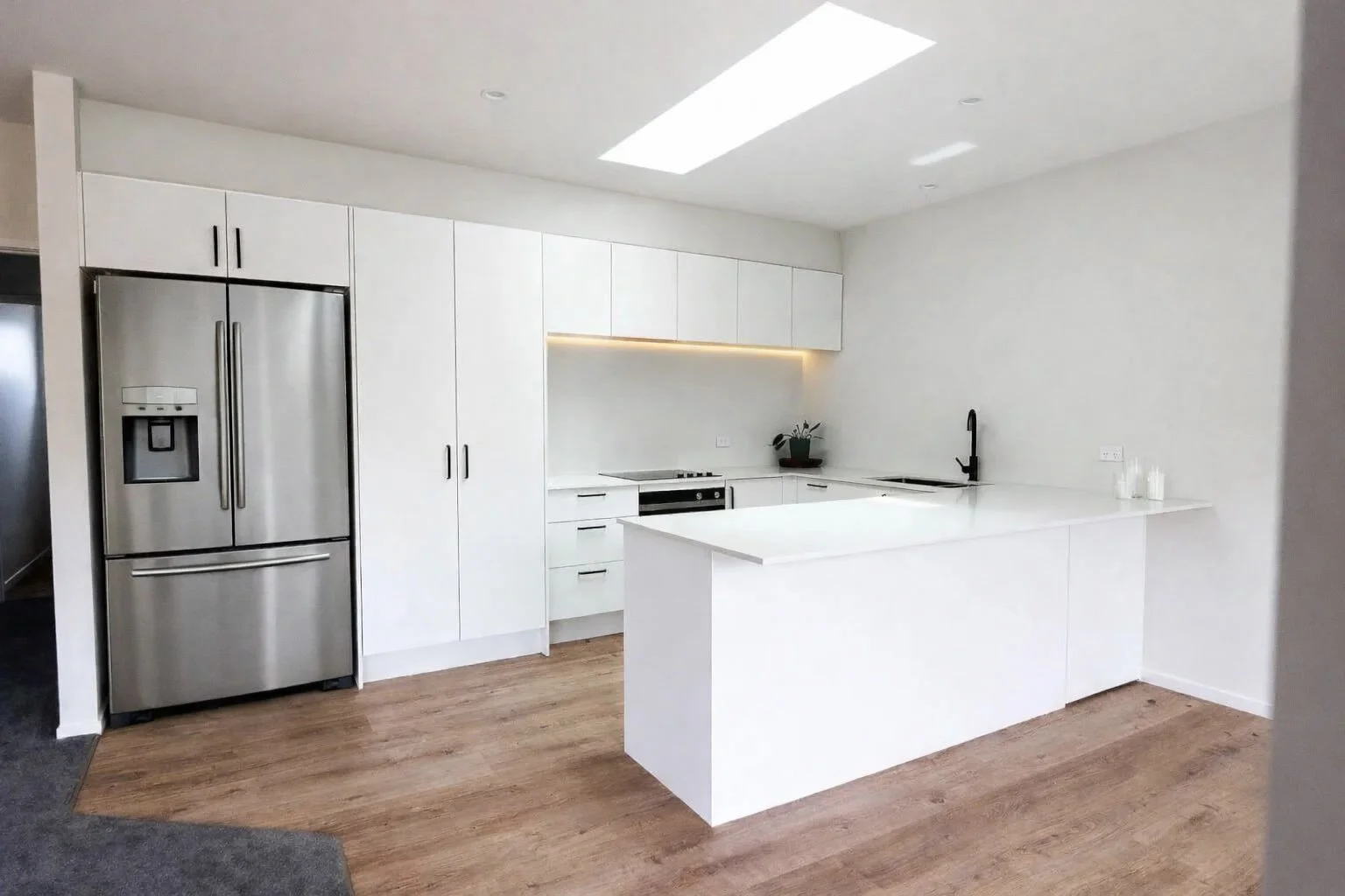 classic white kitchen with stone bench top and breakfast bar