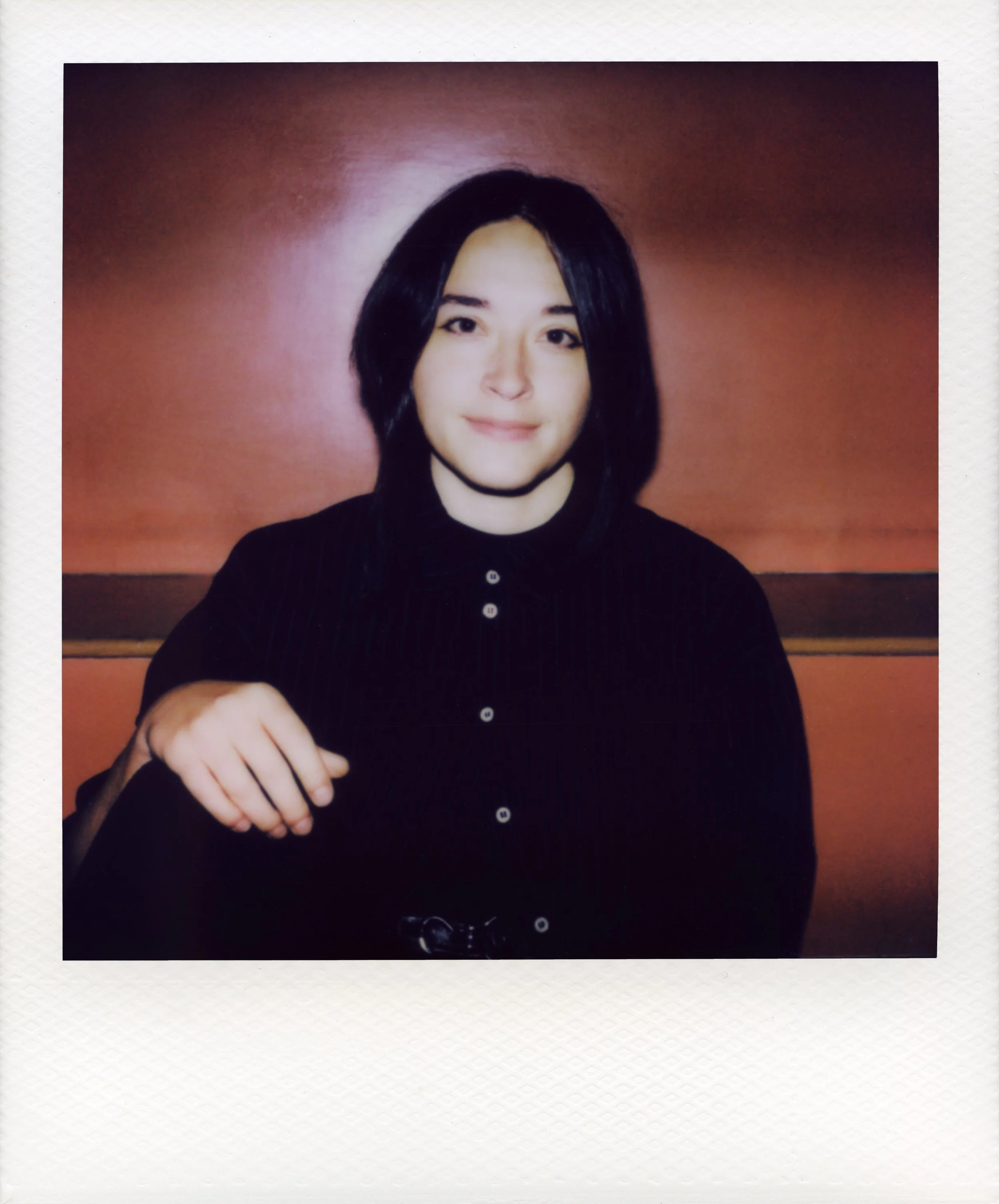 Person with short dark hair and a dark shirt looking into the camera. Photo by Anna Powell Denton