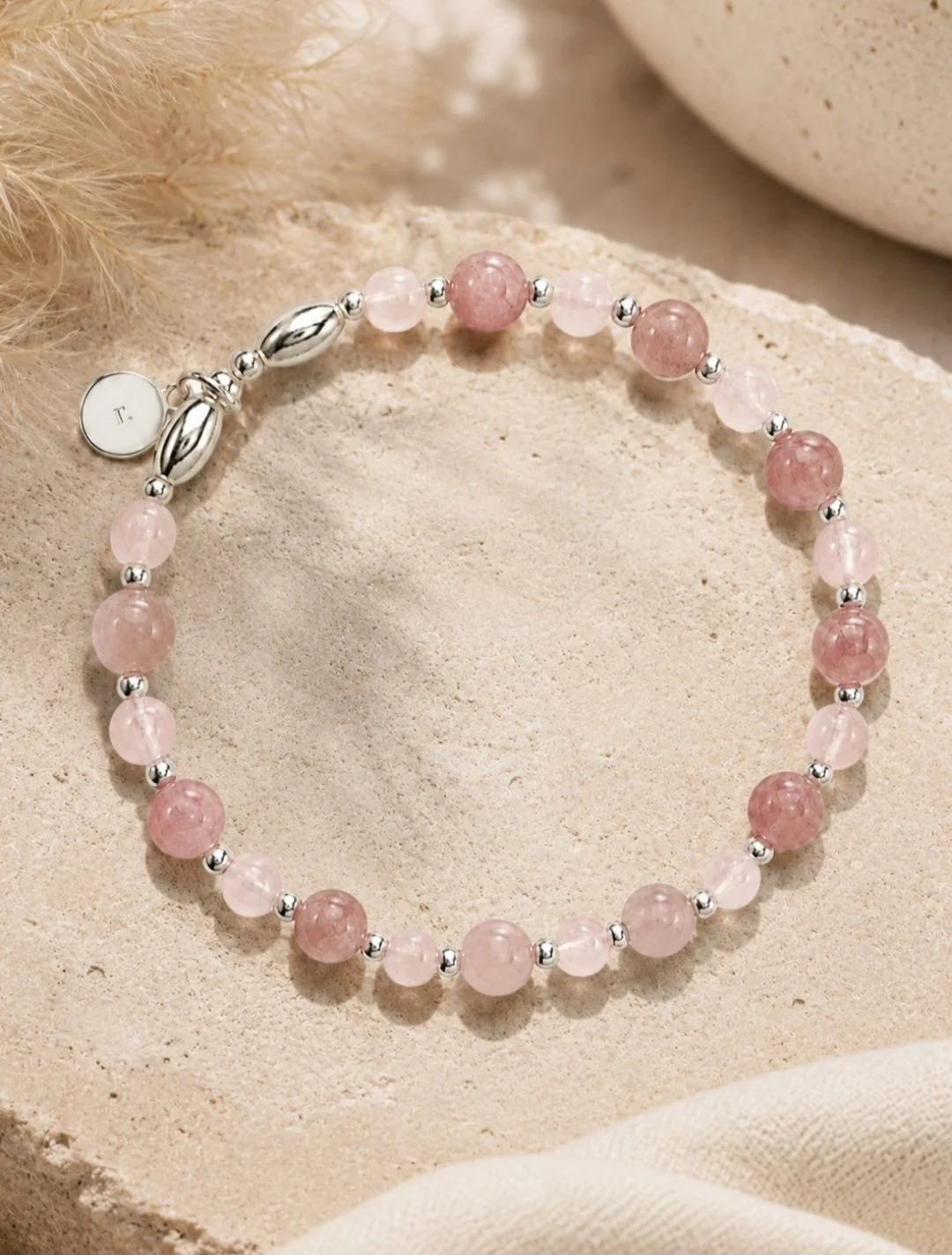 rose quartz bracelet on a sandstone background.jpg