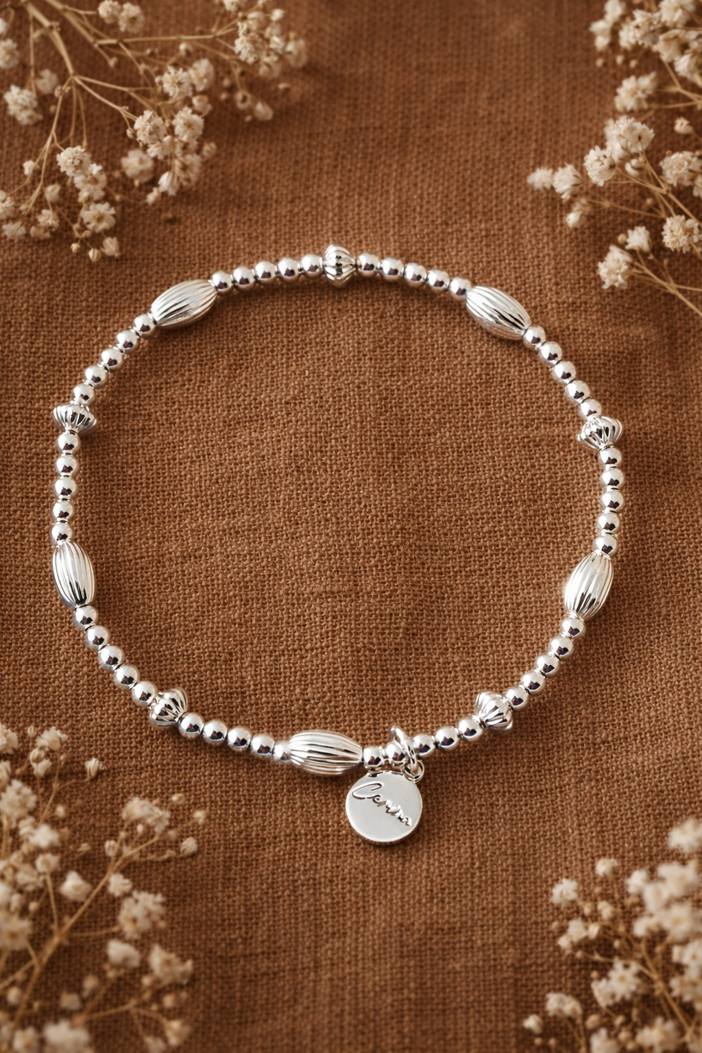 Silver bracelet with personalised charm.png