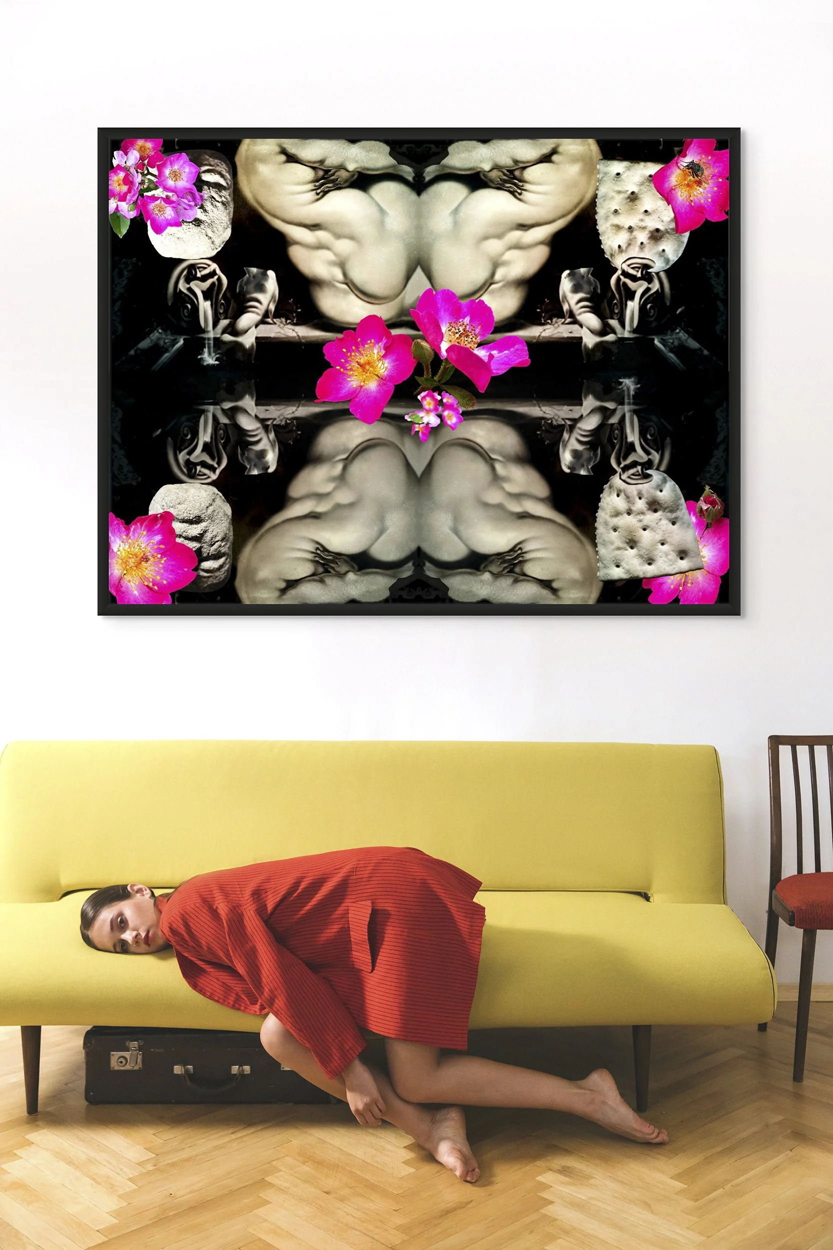 This mock-up shows print of Surrealistic digital composite, Rubenesque Dark Garden:  Reflecting Pool, installed on white wall, above yellow sofa, with reclining person in red garment.