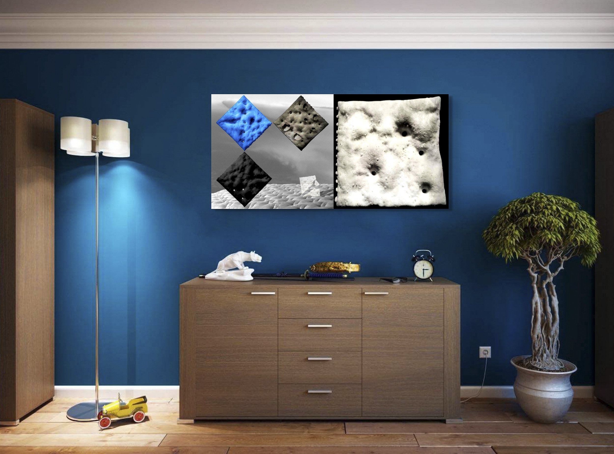 Mock-up showing print of Surrealist digital composite, Cold Steel Hammer 3, on blue wall in room with modern wood furnishings and wood flooring.
