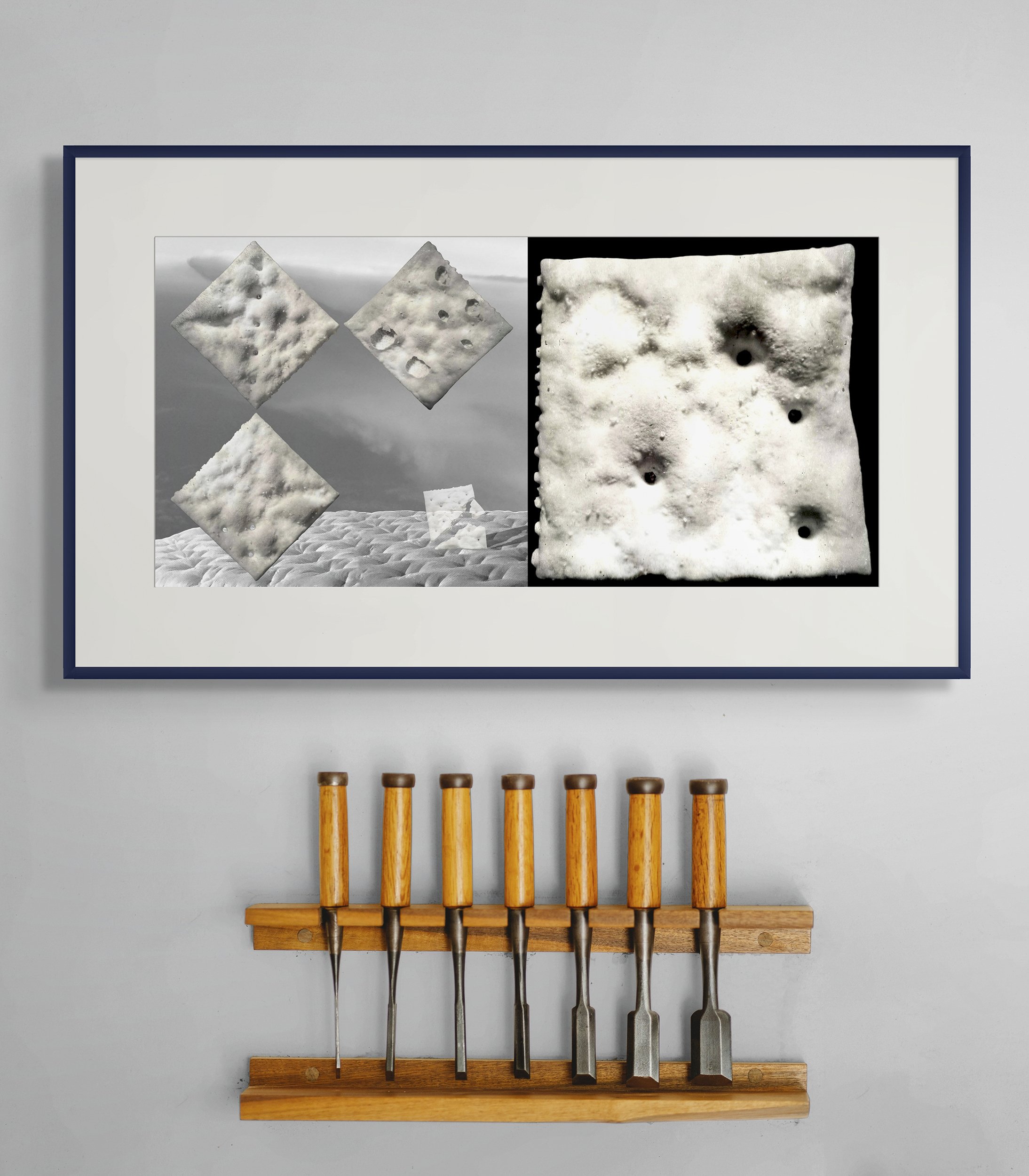 Mock-up showing matted, framed print of Cold Steel Hammer 1 on medium-gray wall, above 7 woodworking chisels with wooden handles.