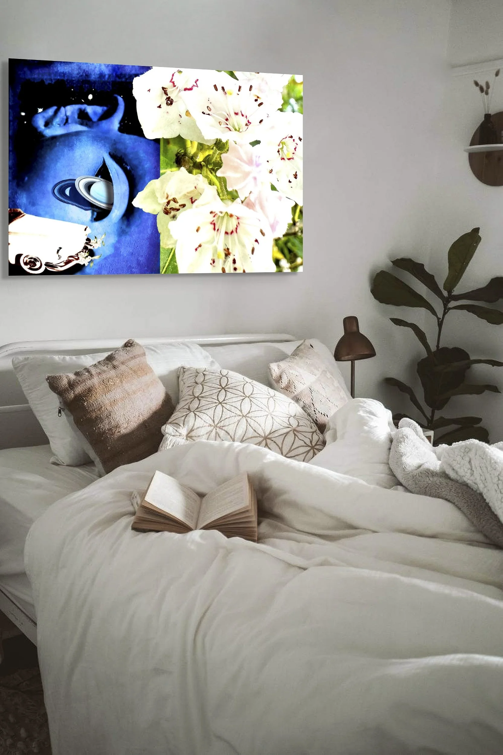 This mock-up shows print of Surrealist digital composite, Nocturne and Laurel, installed on gray wall above rumpled bed with pillows and open book.