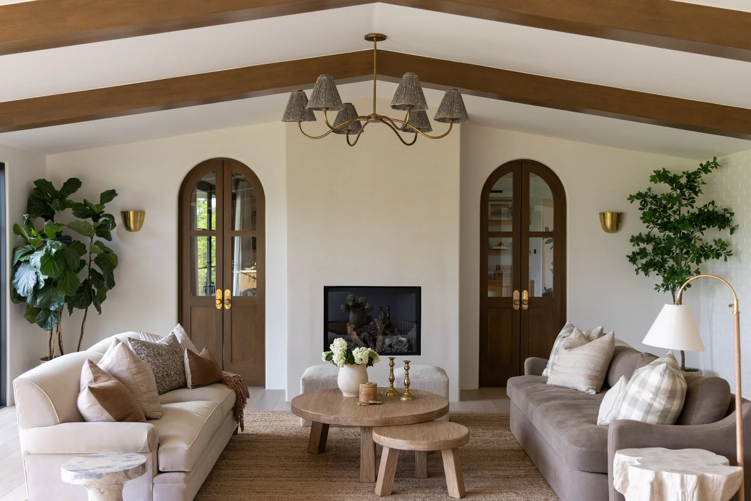 Living room with arched doors and a fireplace in a Phoenix home
