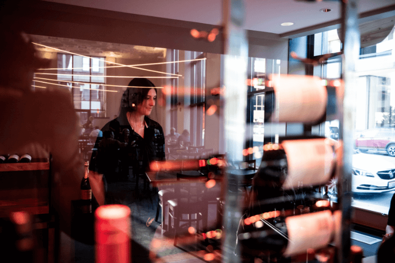 wine-room-reflection-girl-behind-glass-street.png