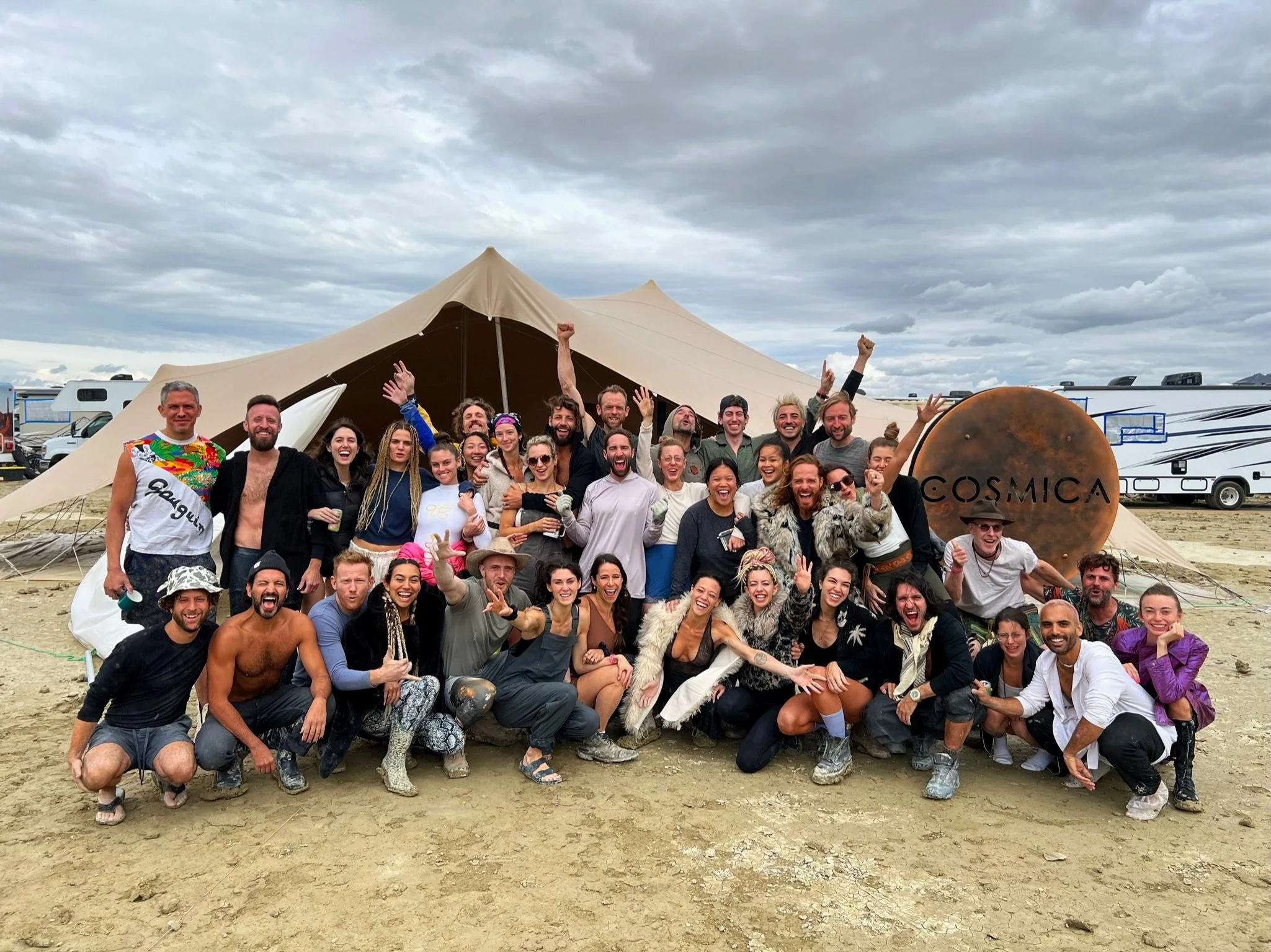 50+ burners in front of large tent with large brass Cosmica sign