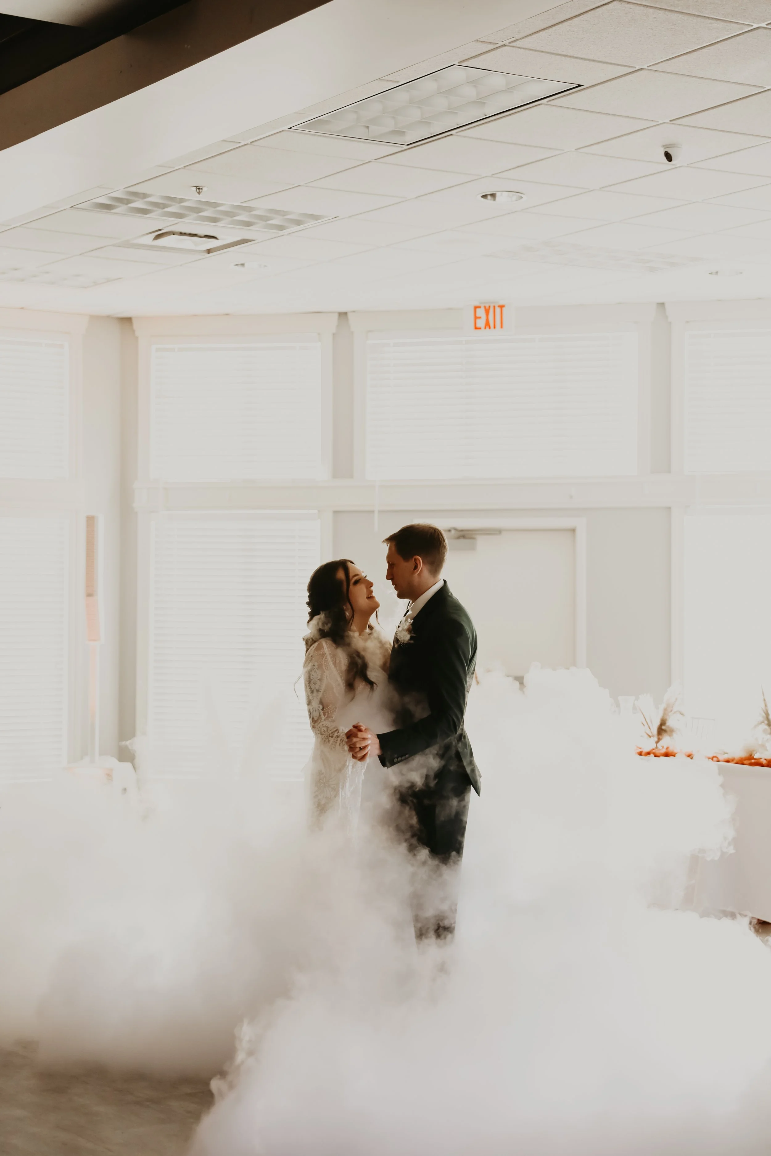 A bride and groom dancing in a decorated indoor wedding venue with fog effects in Sioux Falls, South Dakota.