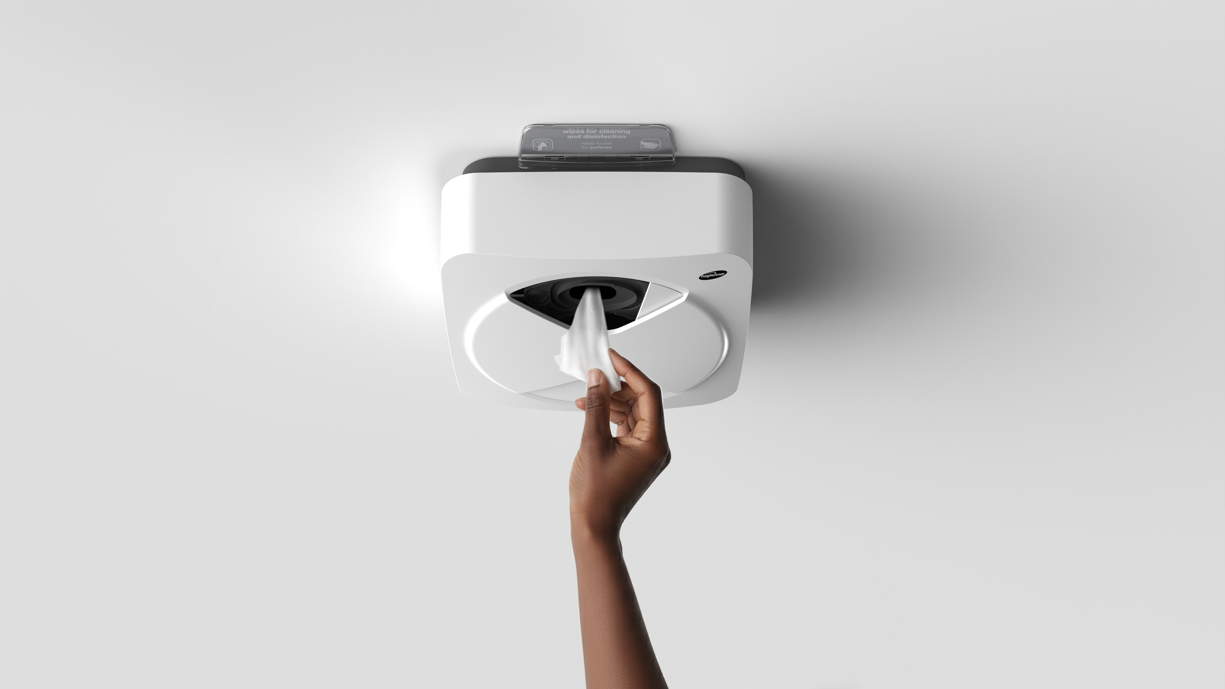 Xibu 2Wipe Hybrid by Hagleitner, designed by Kai Rump and Studio F. A. Porsche, white product on white surface, human hand interacting with the product.