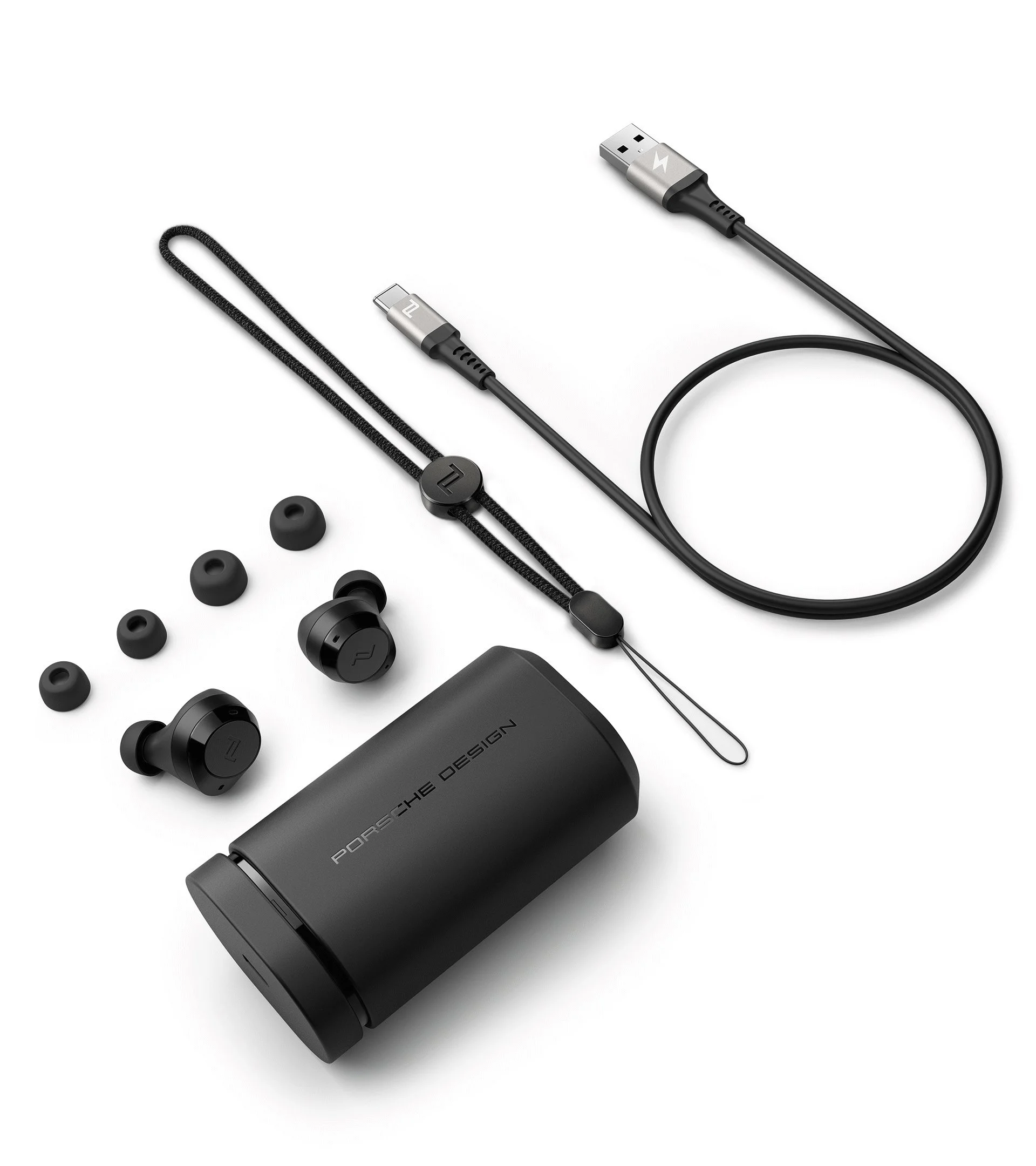 In Ear headphone case, designed by Kai Rump and Studio F. A. Porsche, presented with all accessories on a white surface.