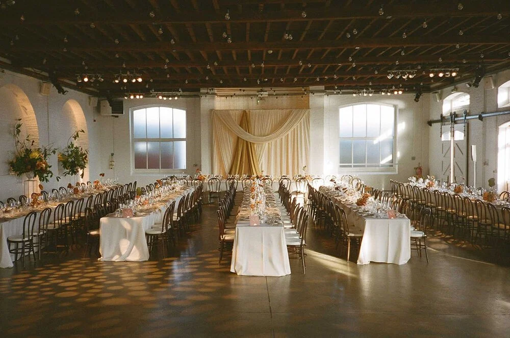 After image of Trinity Buoy Wharf with long wedding tables and contemporary flowers