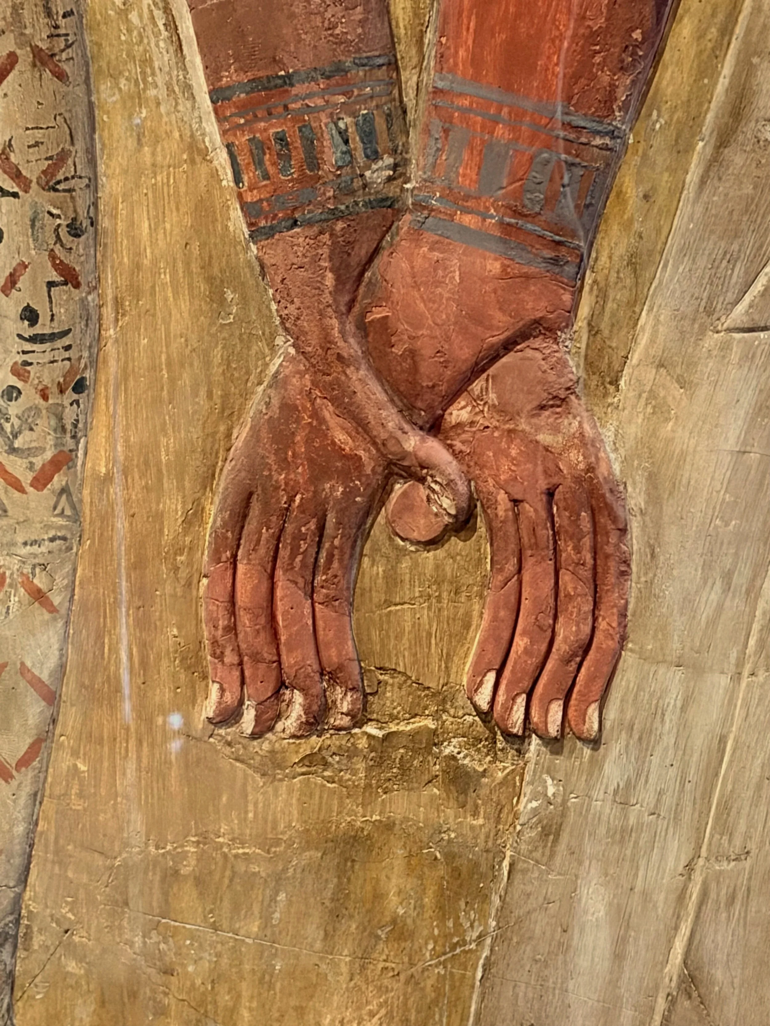 Detail of a painted or carved Egyptian fresco showing two hands in union.