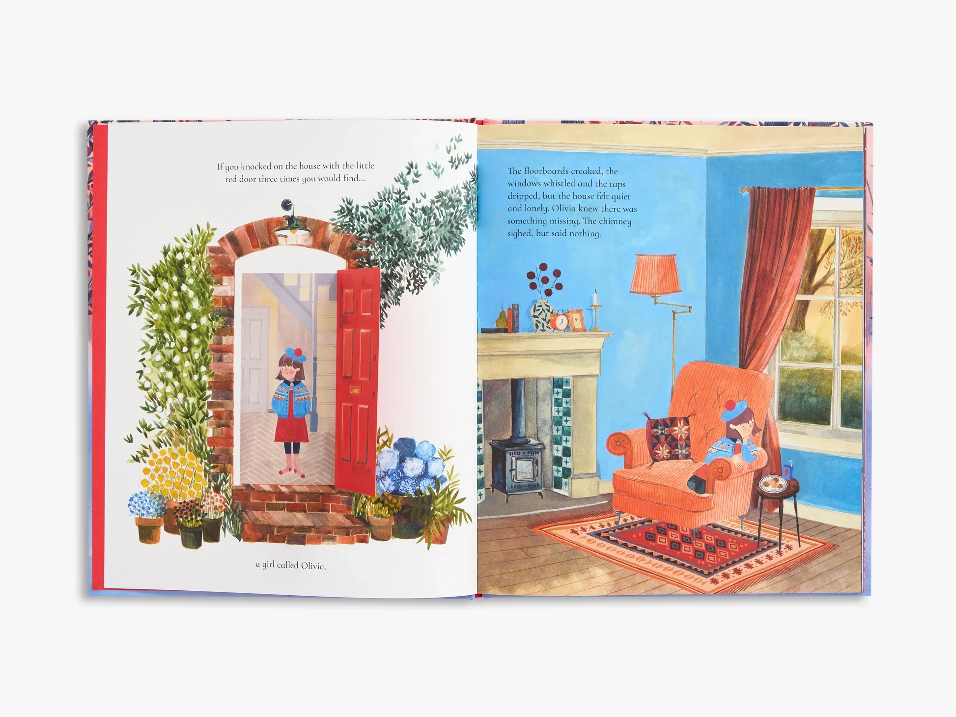 Open illustrated book showing a girl named Olivia standing in front of a red door surrounded by plants, with a cozy blue living room interior including a fireplace, armchair, rug, and window with red curtains.