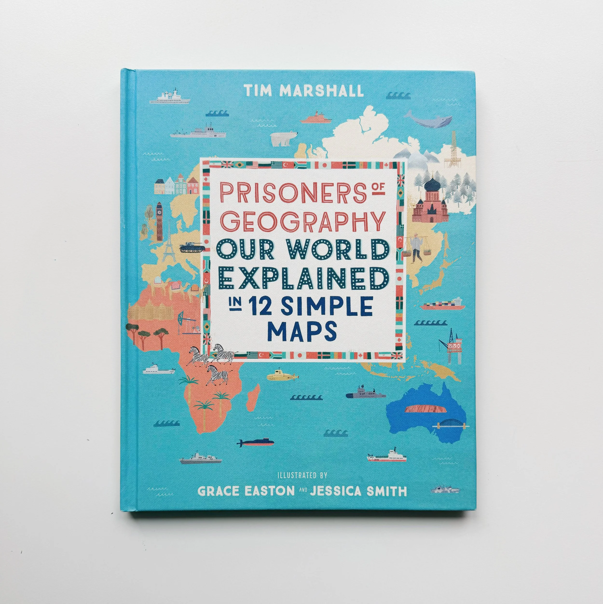 Cover of a book titled 'Prisoners of Geography' with a colorful map of the world including ships, airplanes, animals, and landmarks, written by Tim Marshall.