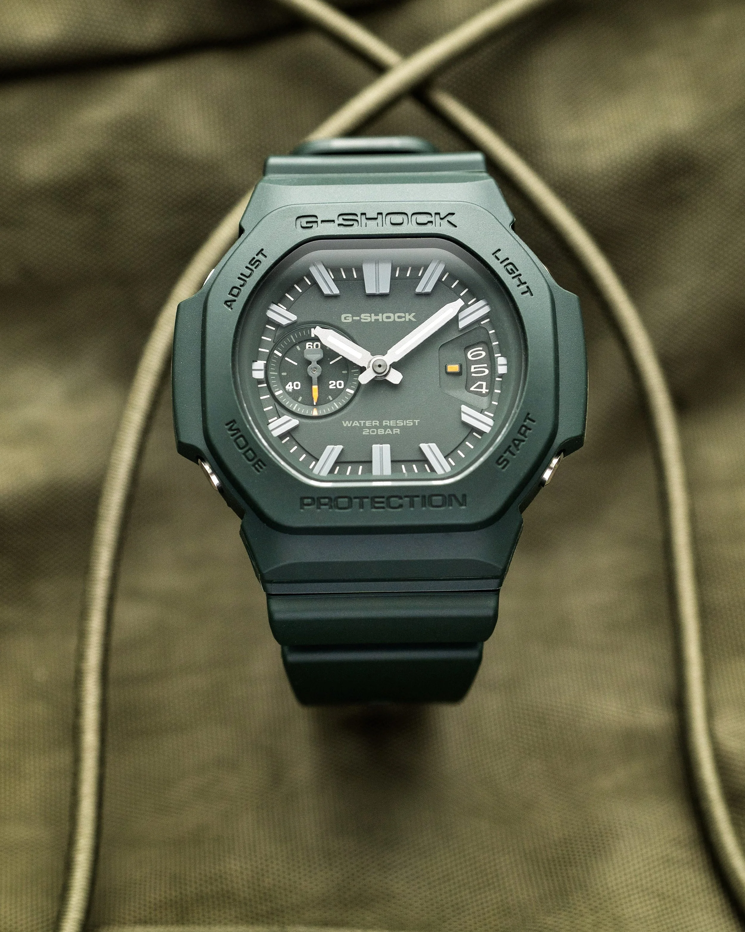 Casio G-SHOCK GAC-2500-3A CasioNaut featuring a dark green resin case and strap, matching analogue dial, silver-tone hour markers and subtle orange accents.