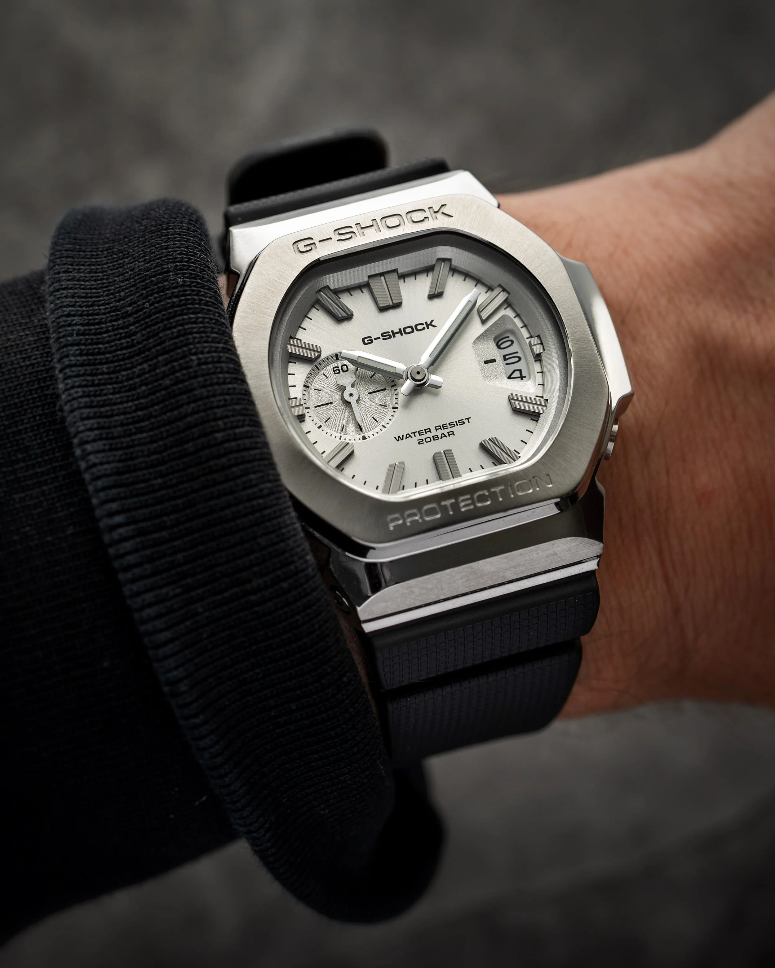 Casio G-SHOCK GMC-2500-1A8 CasioNaut on the wrist, showing its textured silver analogue dial, raised hour markers, brushed metal bezel and black resin strap.