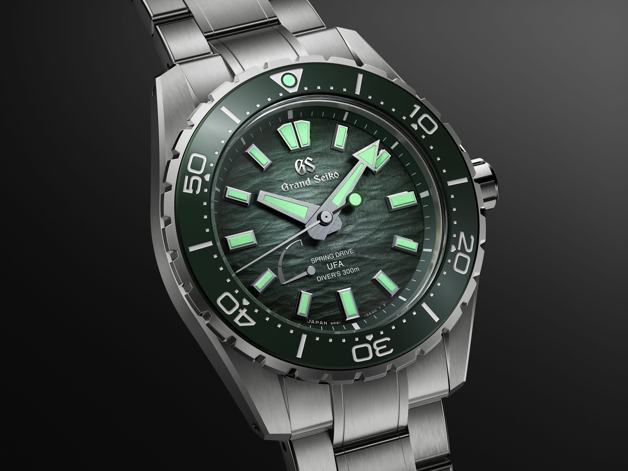 Grand Seiko SLGB025 Ushio 300 Diver close-up showing the green textured dial, titanium bracelet and LumiBrite markers.