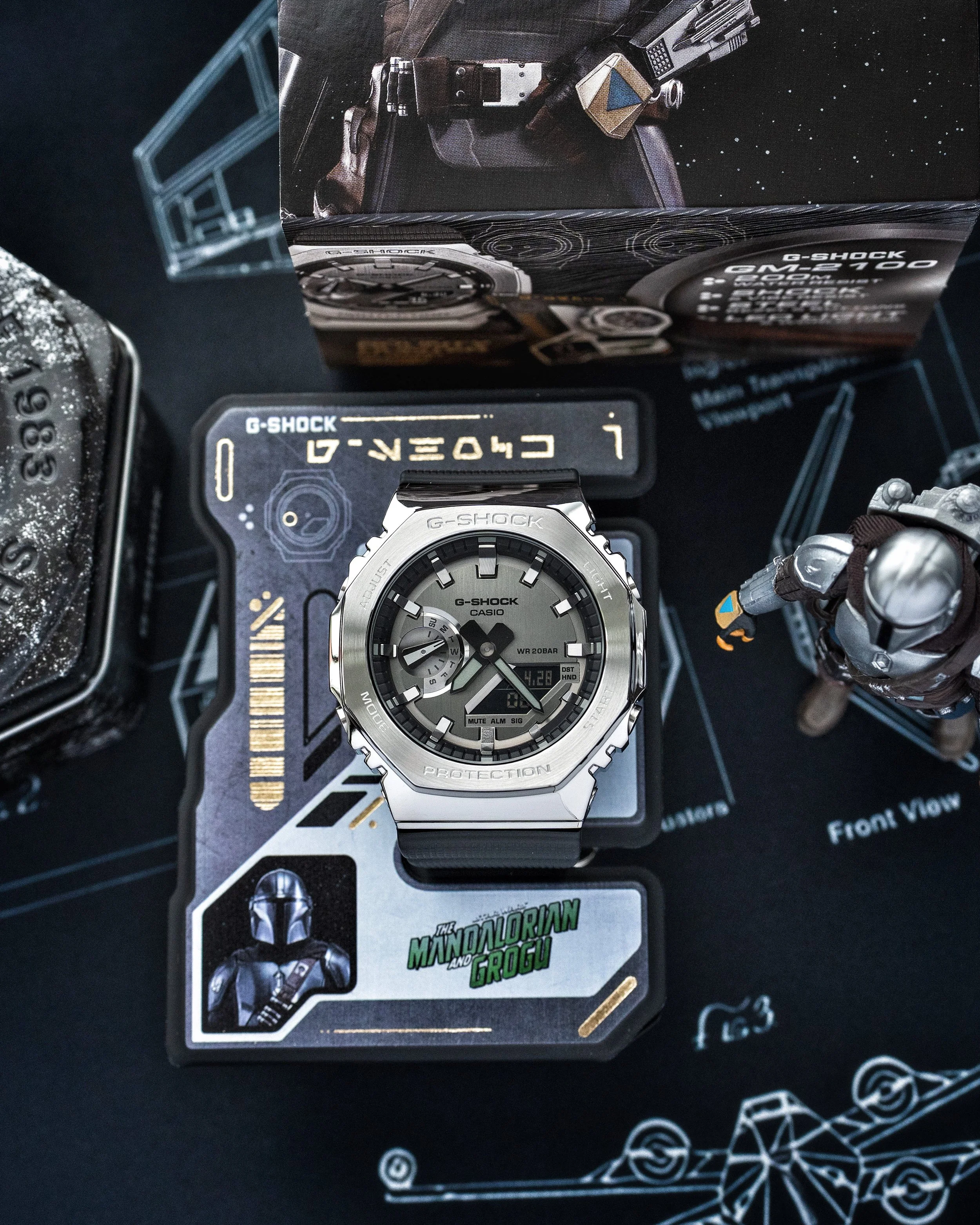 G-SHOCK GM-2100 Mandalorian watch displayed on its Bounty Hunter ID stand with themed Star Wars packaging