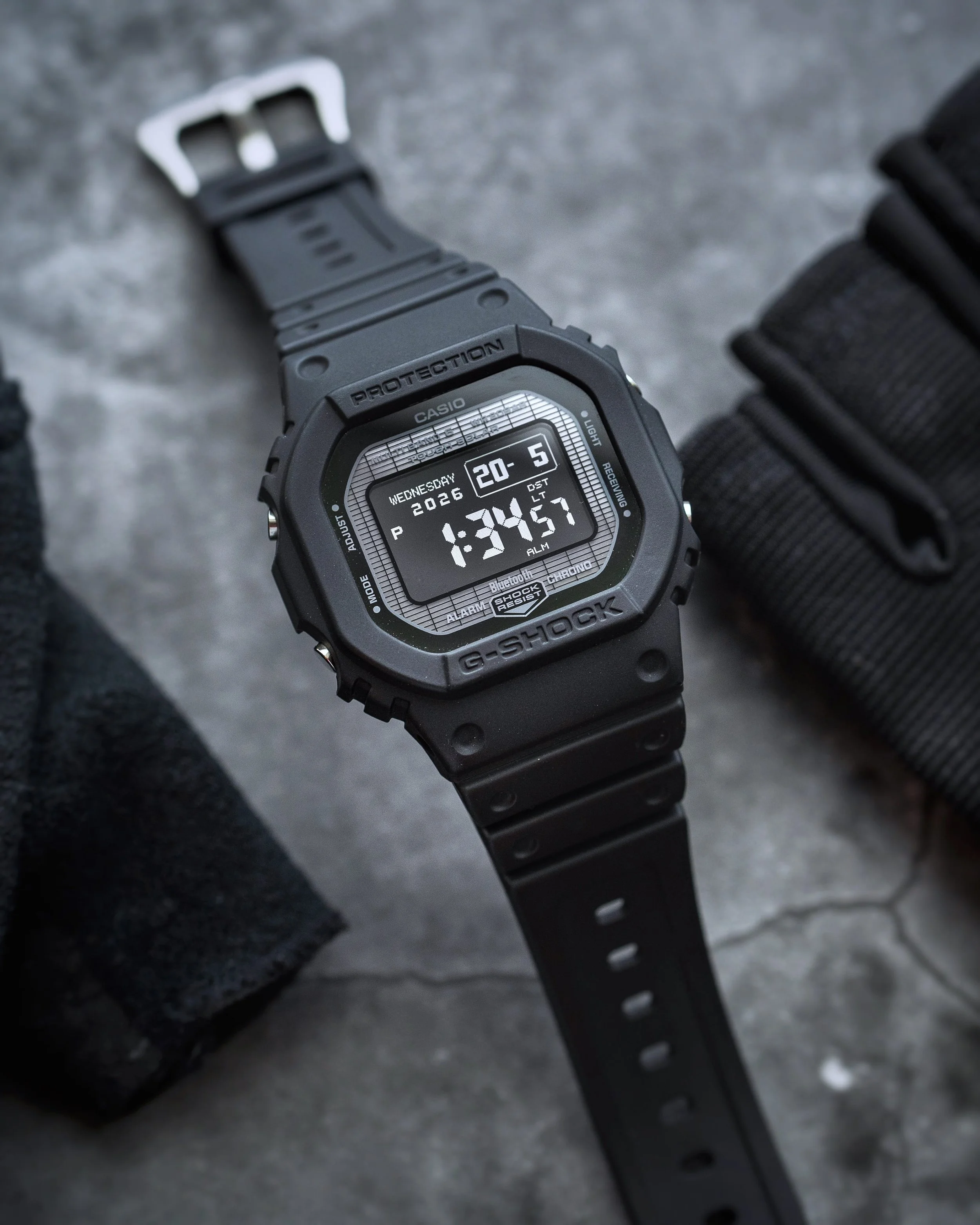 G-SHOCK GW-BX5600-1A1 black square watch showing the negative MIP display and resin strap