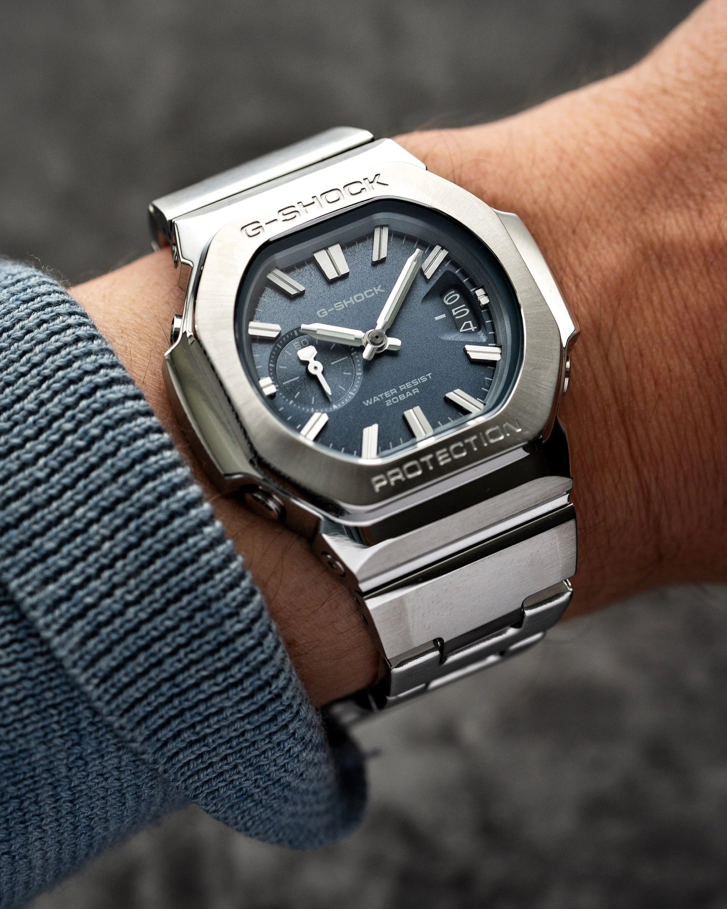 Casio G-SHOCK GMC-2500D-1A2 CasioNaut worn on the wrist, featuring a textured blue dial, brushed stainless steel bezel, polished case edges and matching metal bracelet.