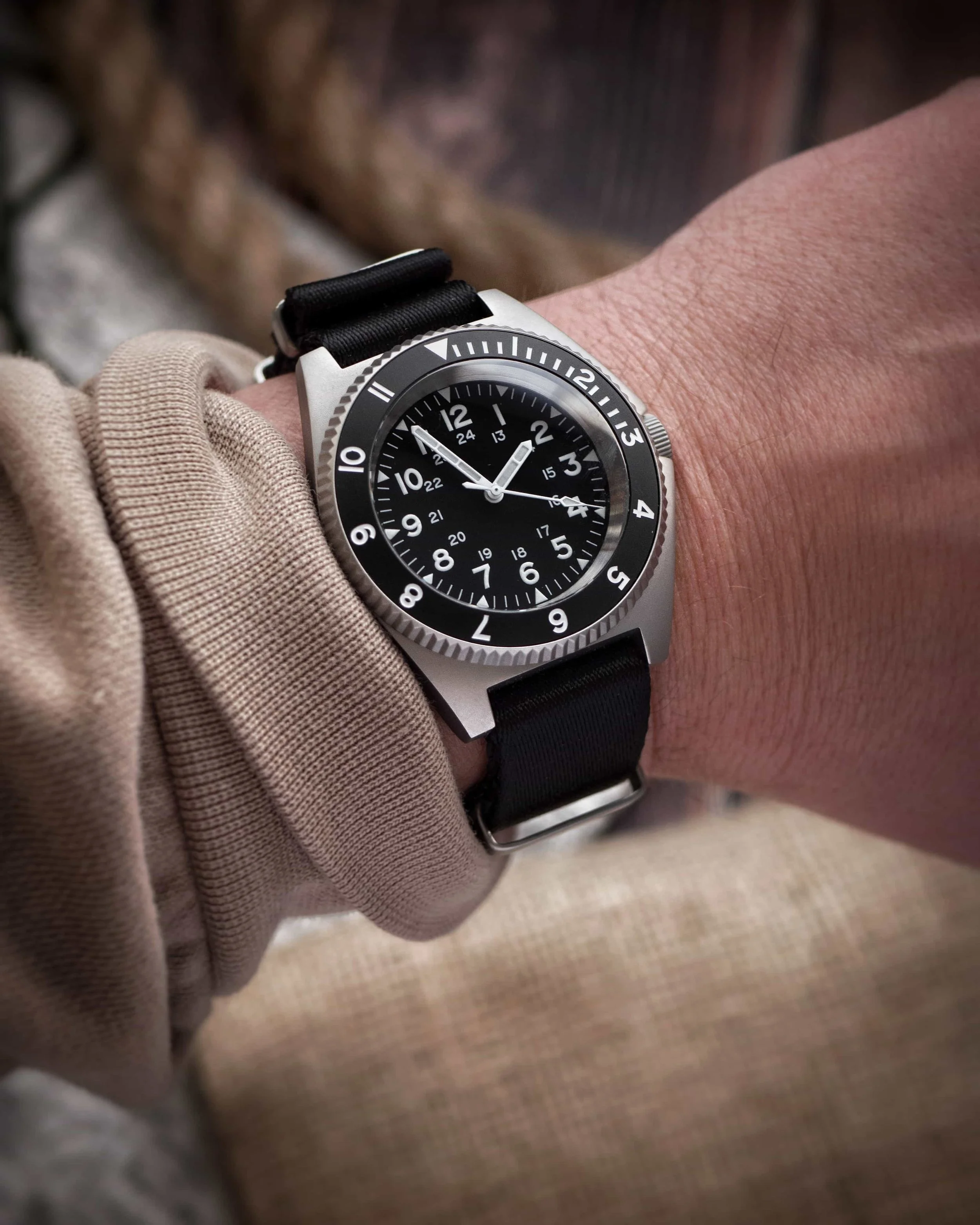 Namoki NMK20 field watch worn on a black NATO strap