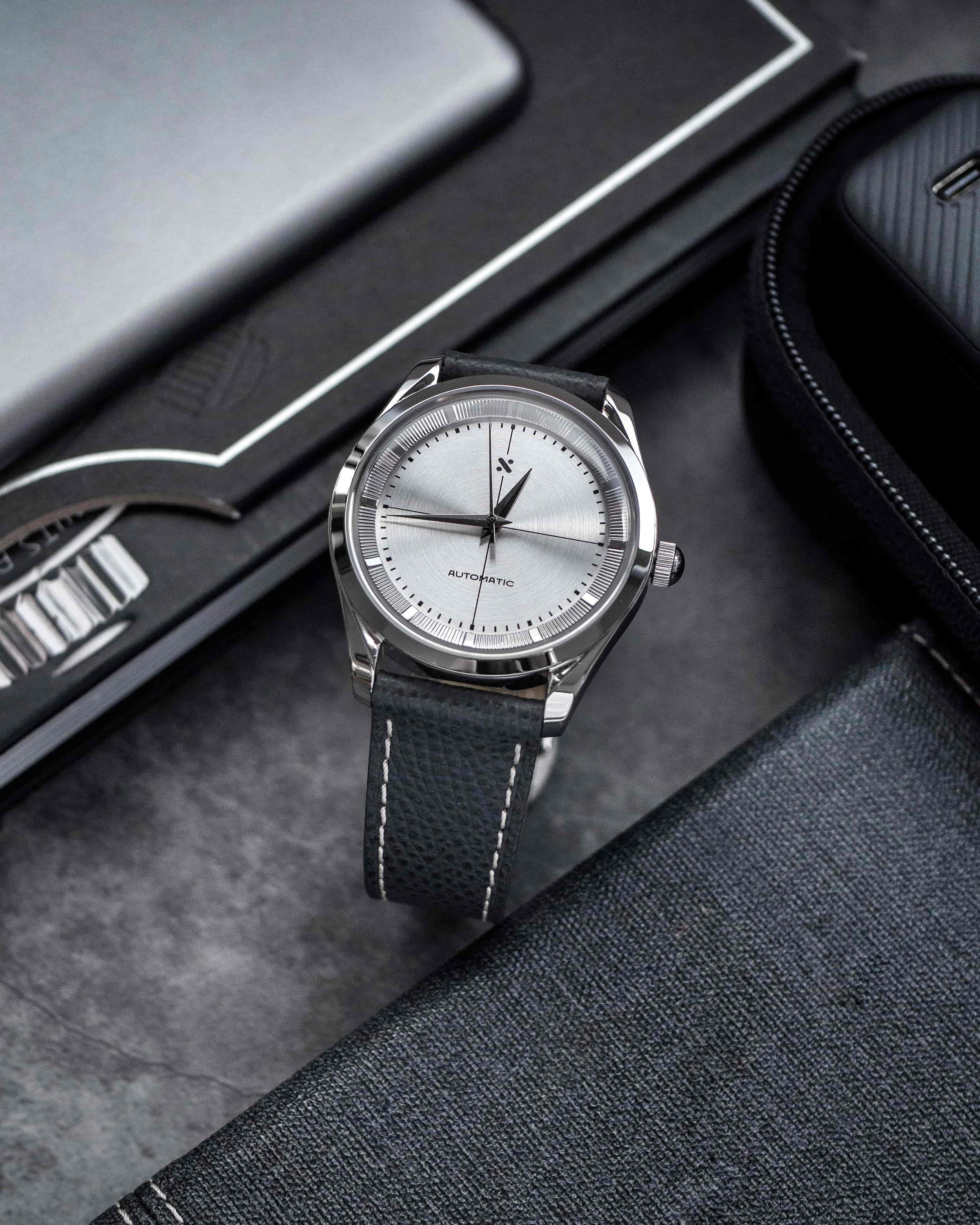 Namoki Polerouter-inspired watch with silver crosshair dial and grey leather strap