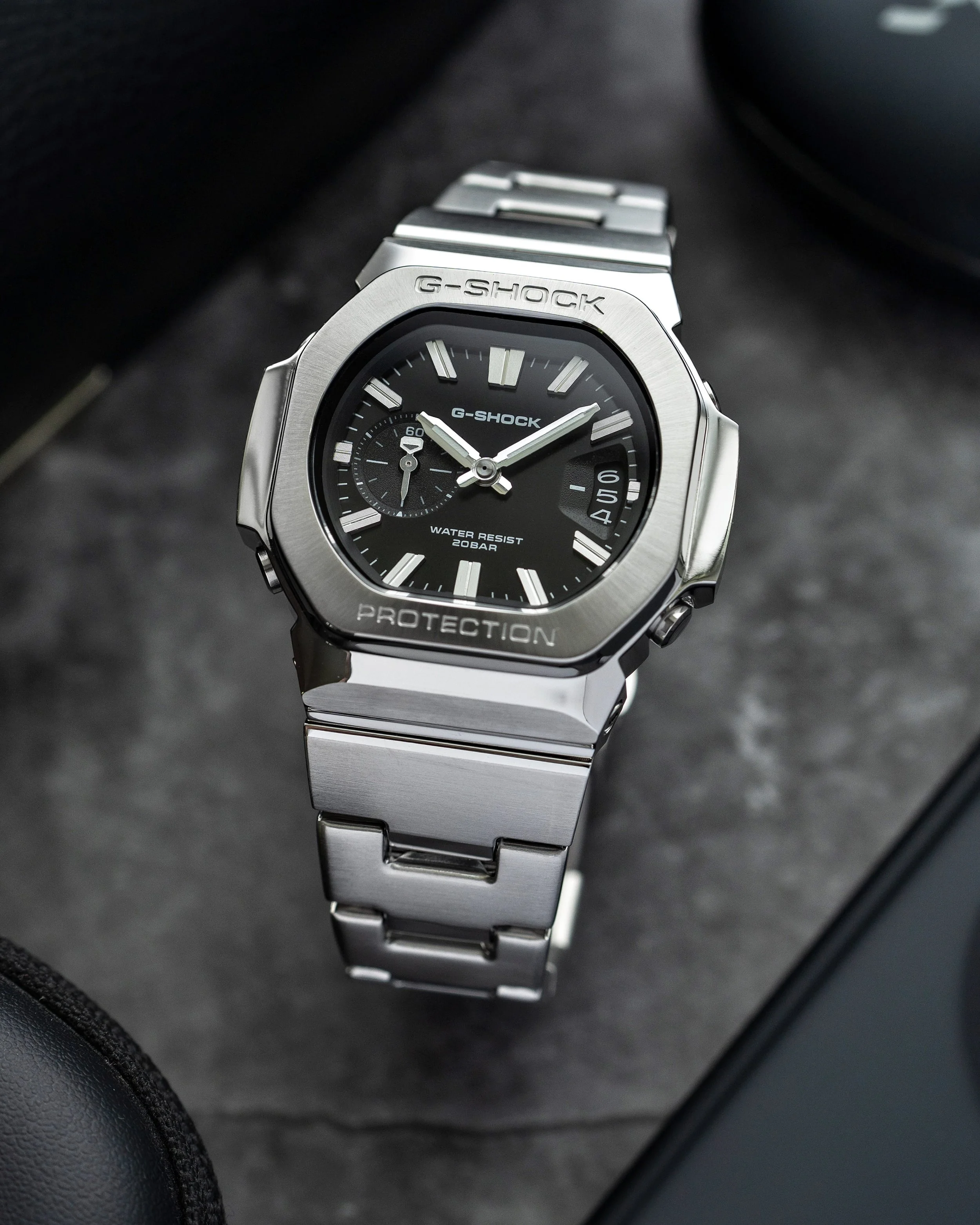 Casio G-SHOCK GMC-2500D-1A CasioNaut featuring a black analogue dial, raised silver hour markers, brushed stainless steel bezel and matching metal bracelet.