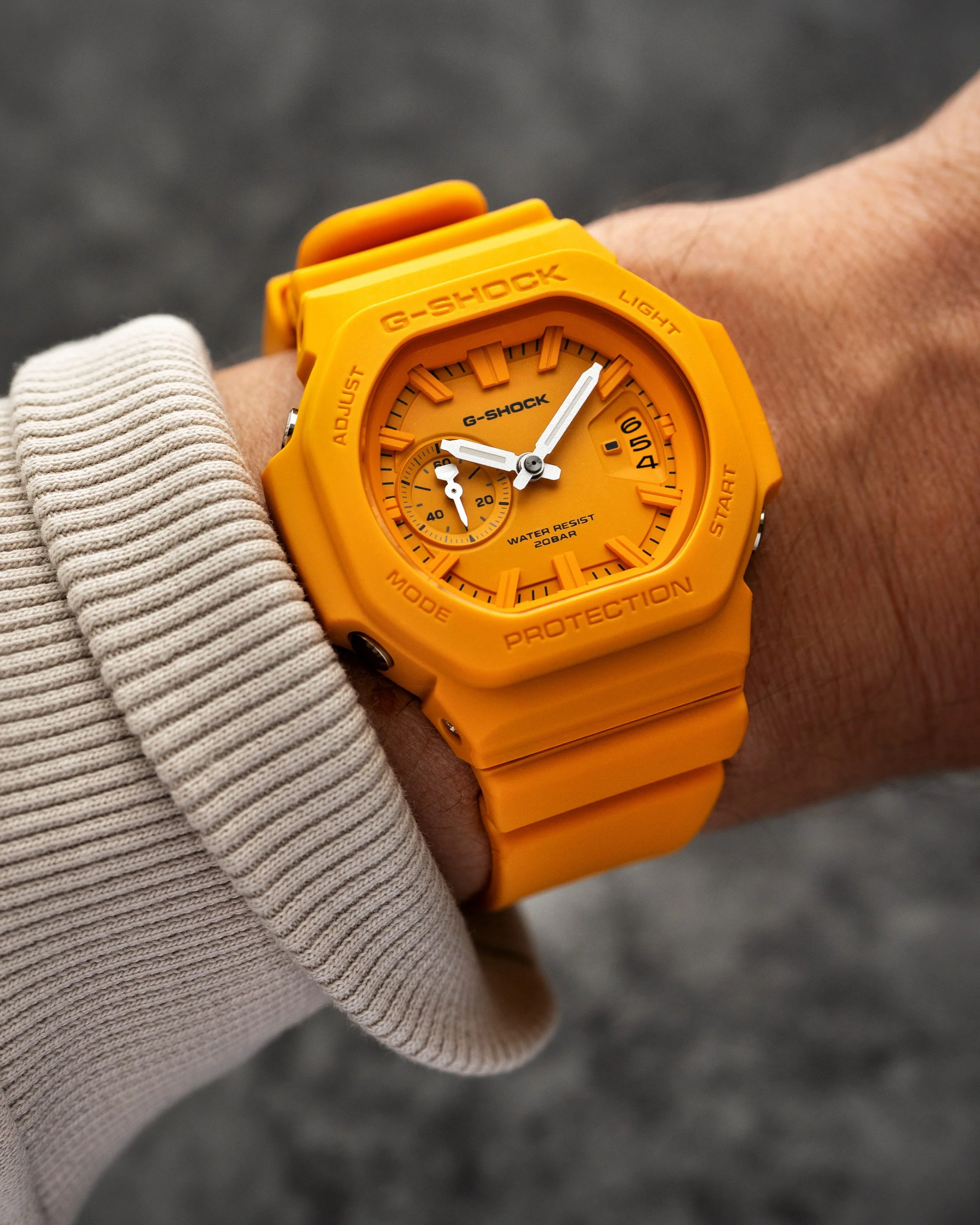 Casio G-SHOCK GAC-2500-9A CasioNaut worn on the wrist, featuring a warm yellow resin case and strap, matching analogue dial, white hands and raised hour markers.