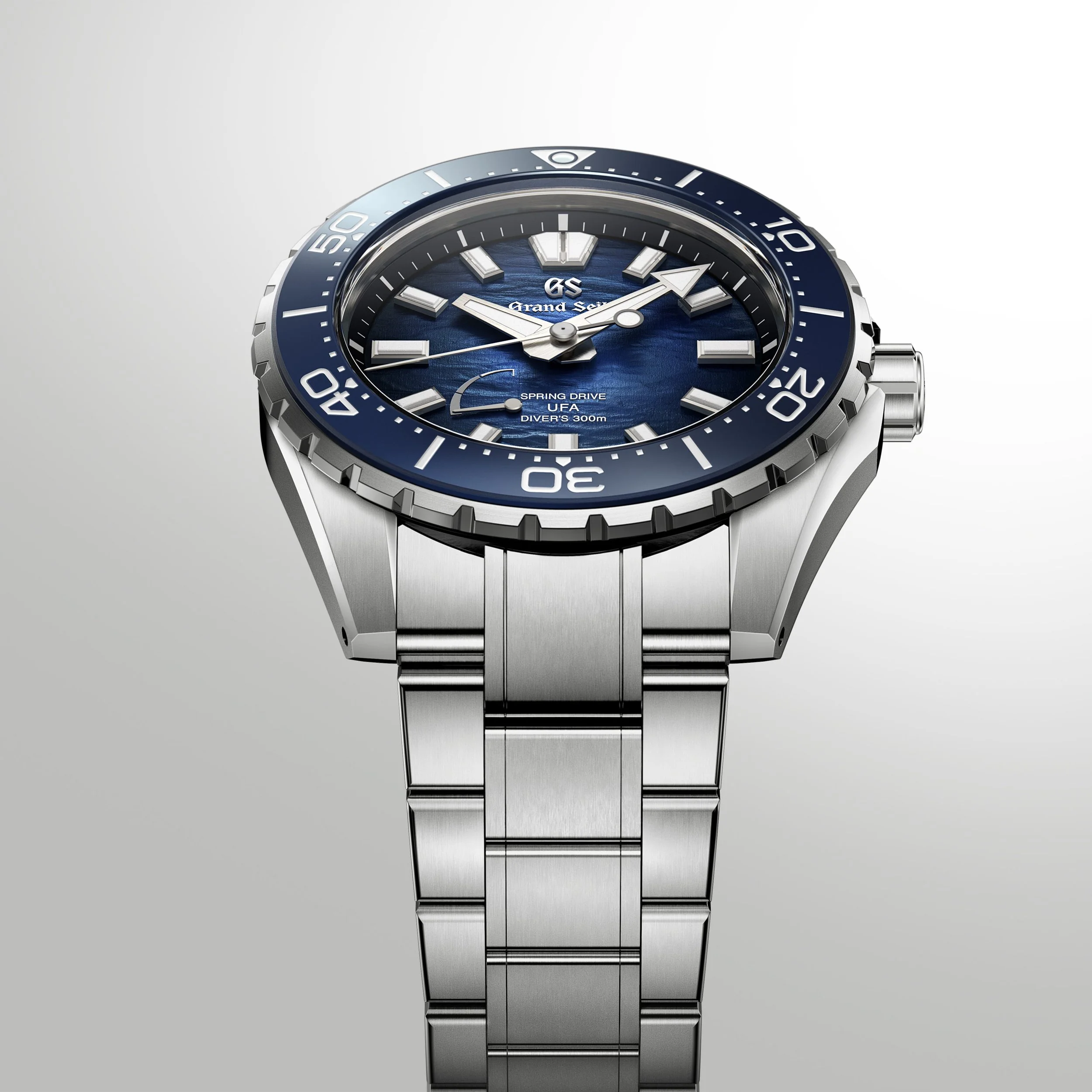Grand Seiko SLGB023 Ushio 300 Diver showing the blue textured dial, titanium bracelet and side profile.
