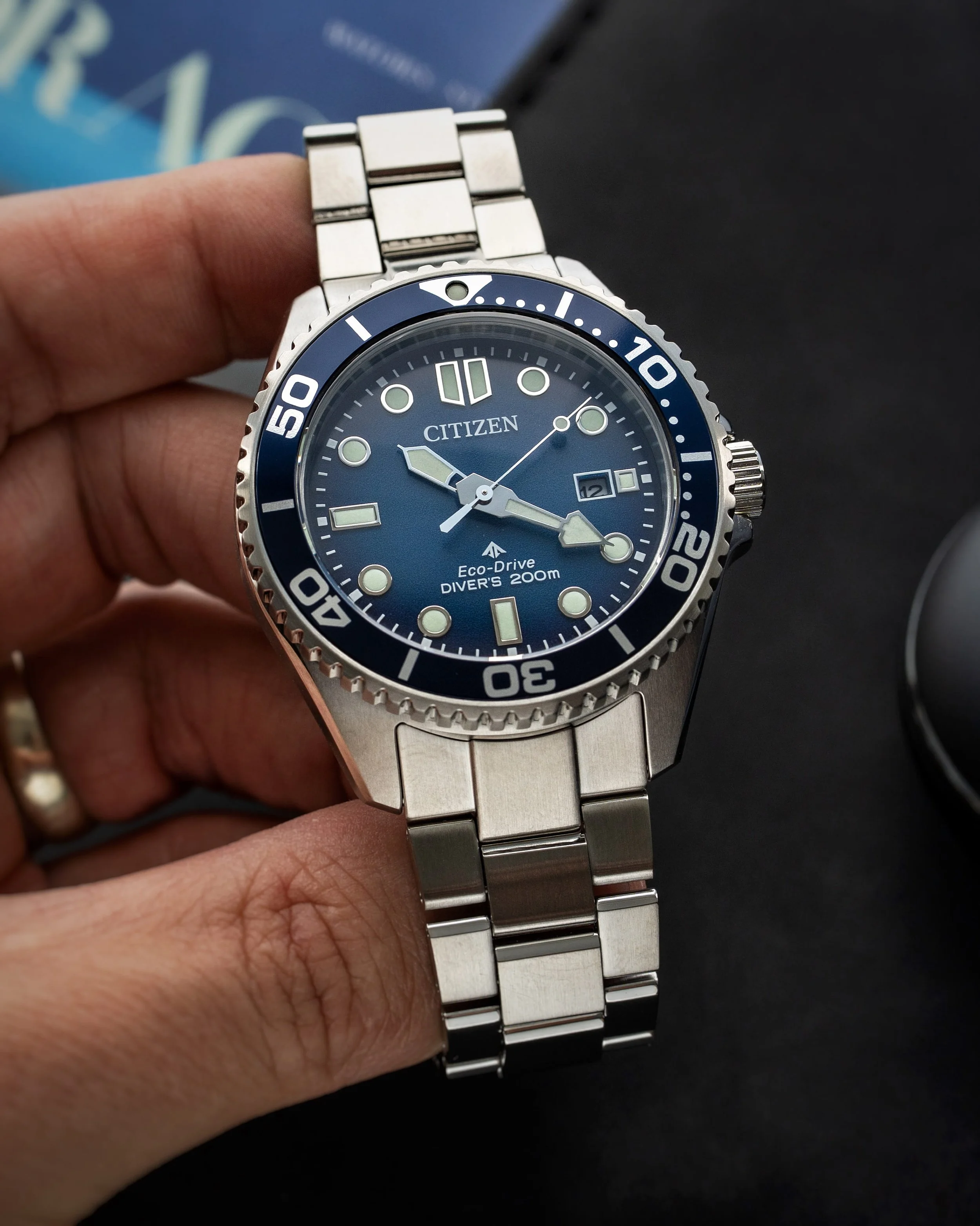 Citizen Promaster BN0260-54L held in hand showing the blue gradient dial and 41mm stainless-steel case.