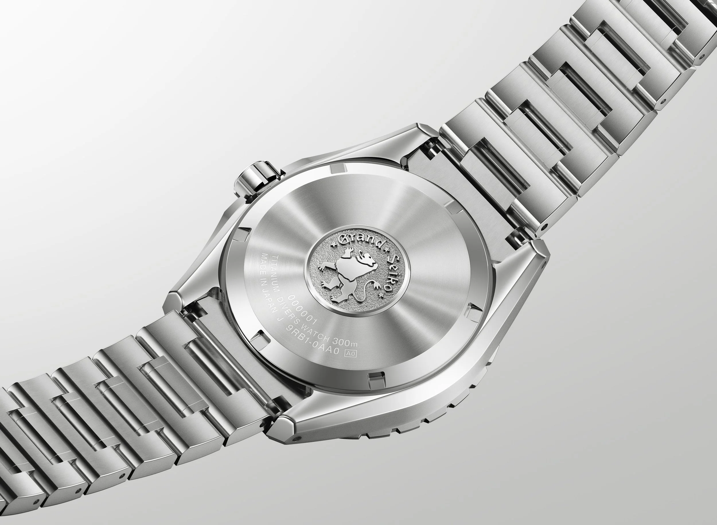 Caseback of the Grand Seiko Ushio 300 Diver showing the titanium case, bracelet and Grand Seiko medallion.