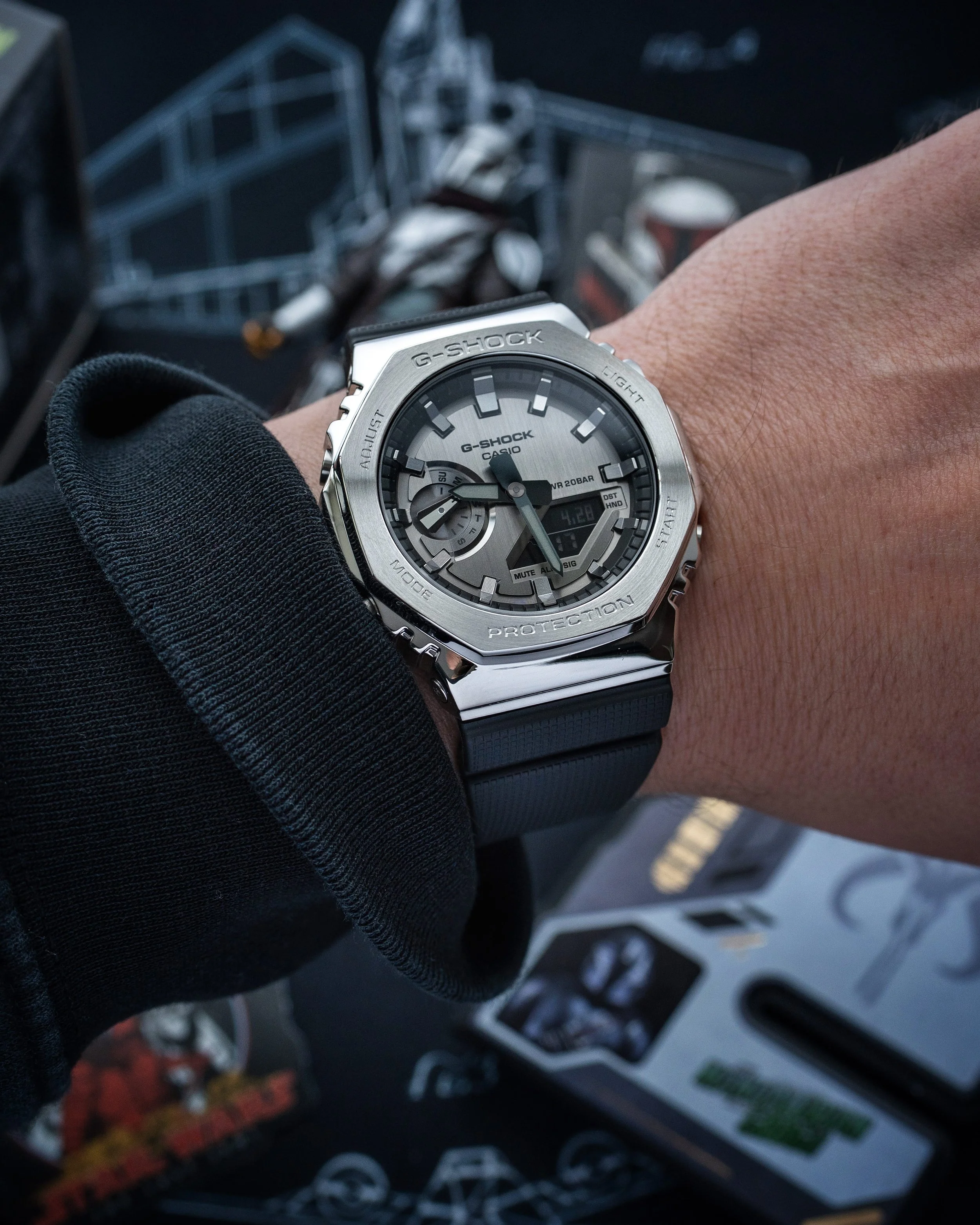 G-SHOCK GM-2100 Mandalorian watch shown on wrist with dark Beskar-inspired metal bezel and black resin strap