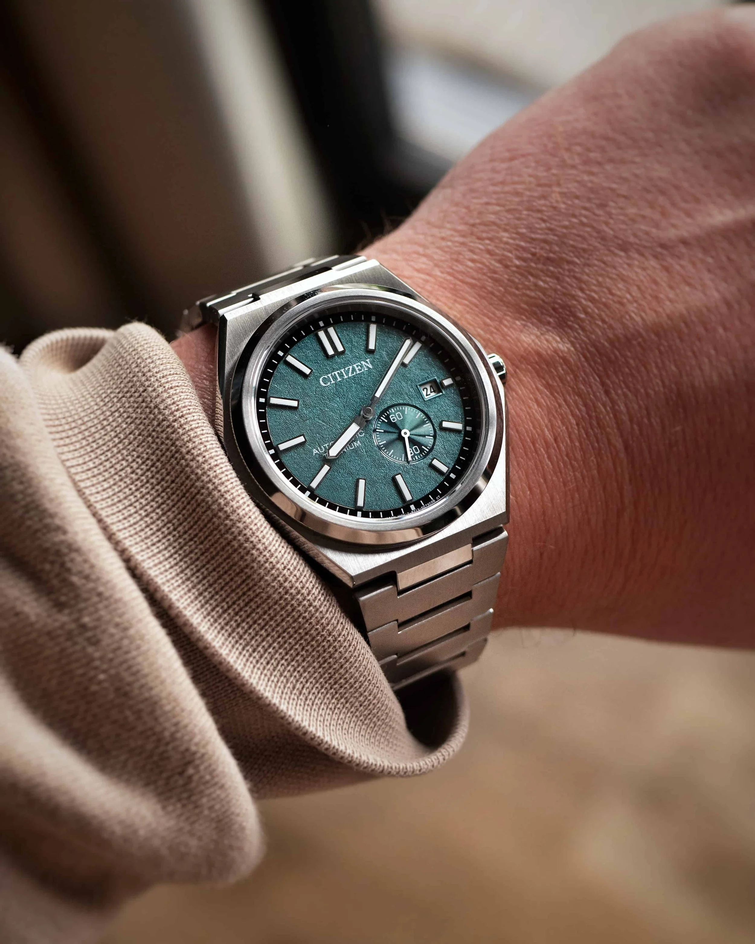 Citizen Zenshin NJ0180-80X Super Titanium small seconds on wrist with green textured dial.