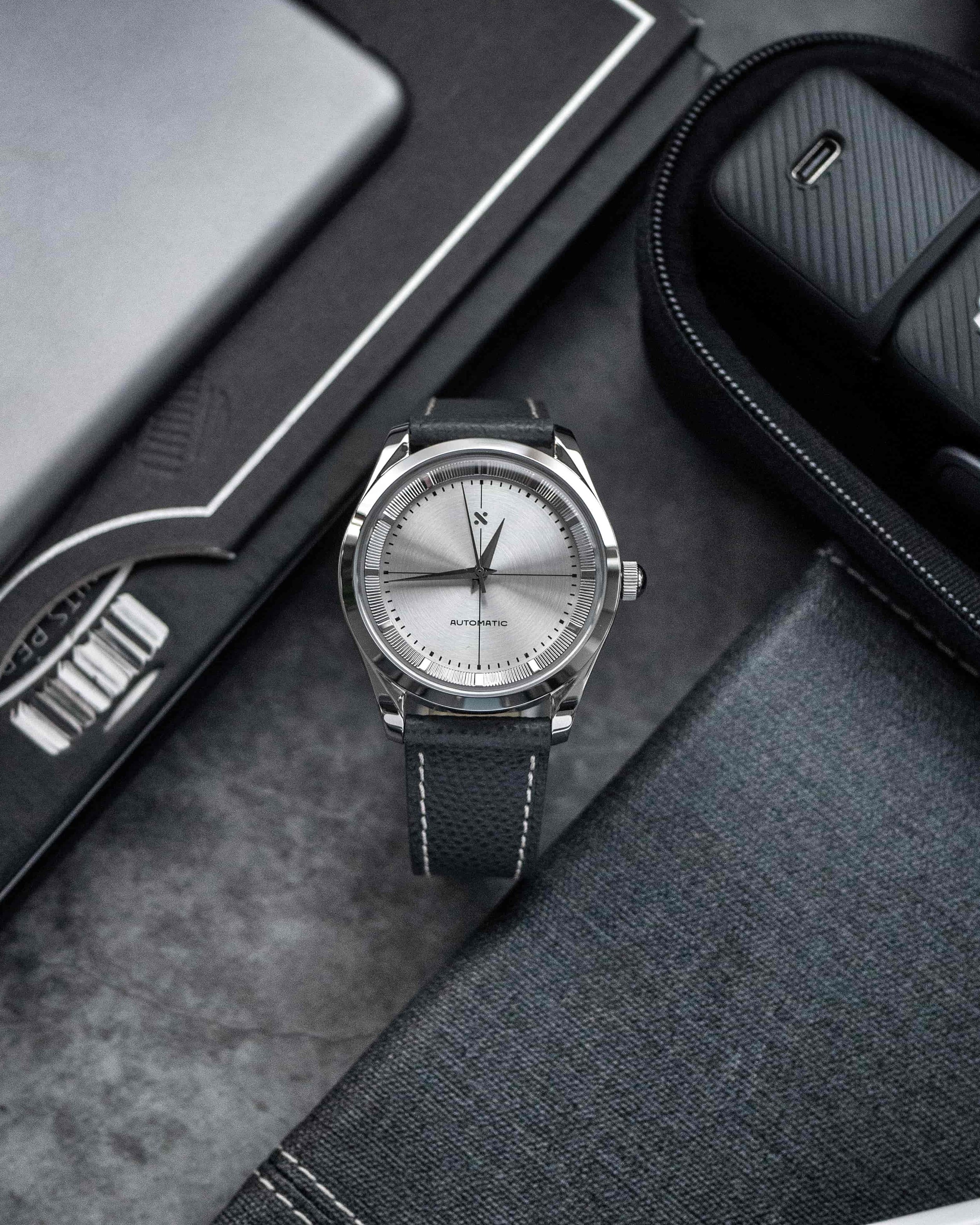 Front view of the Namoki PR silver dial and engine-turned inner ring