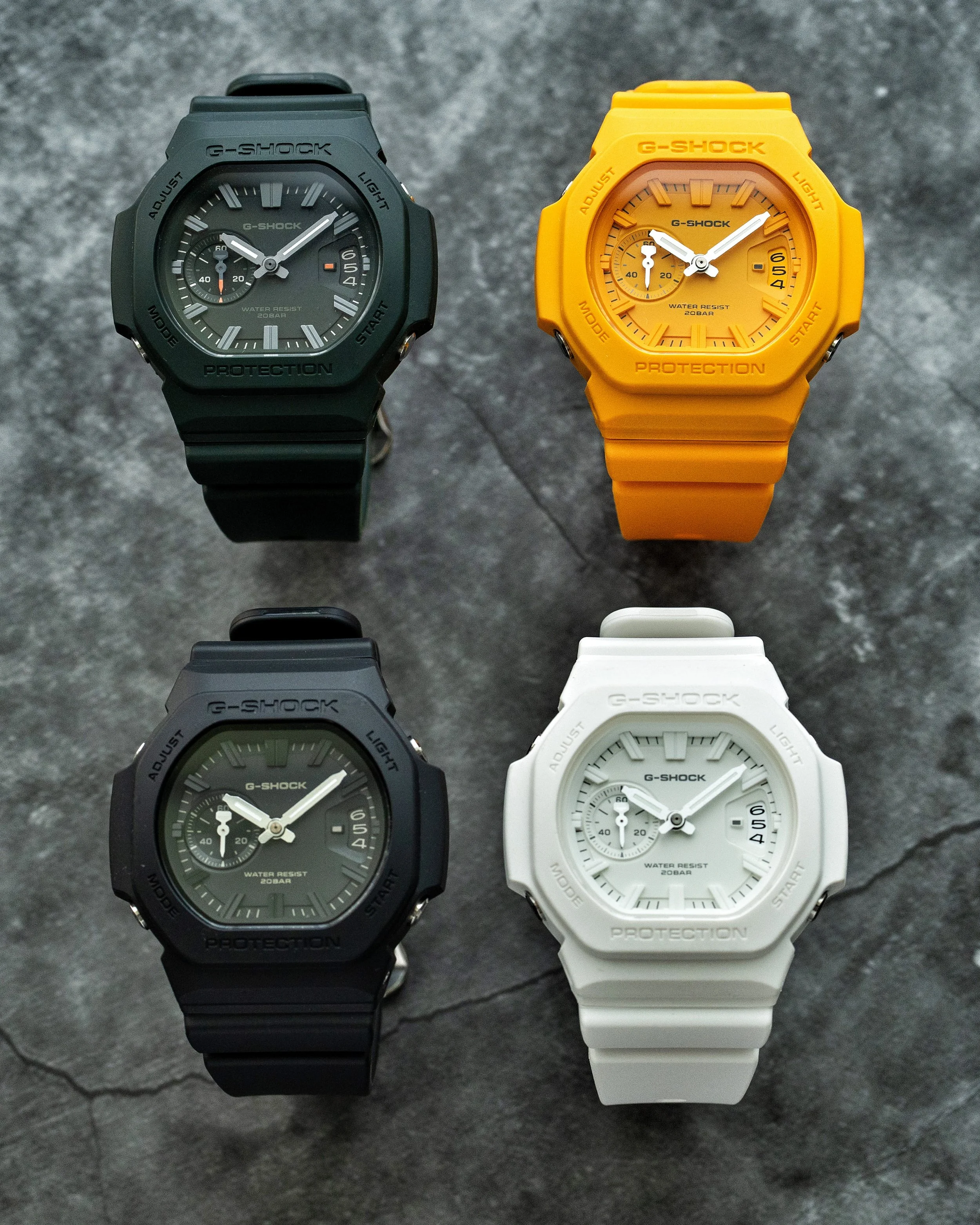 Four Casio G-SHOCK GAC-2500 CasioNaut resin watches arranged together, showing the dark green GAC-2500-3A, warm yellow GAC-2500-9A, black GAC-2500-1A and white GAC-2500-7A colourways.
