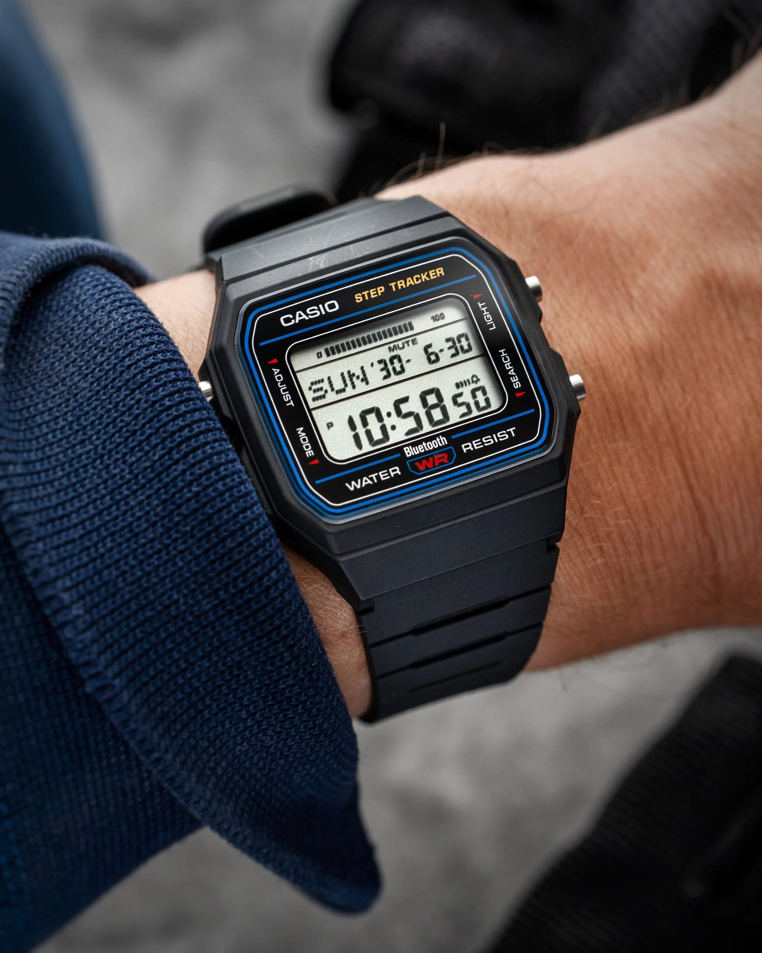 Casio F-B100W-1AJF black digital watch worn on wrist with Bluetooth and step tracker display
