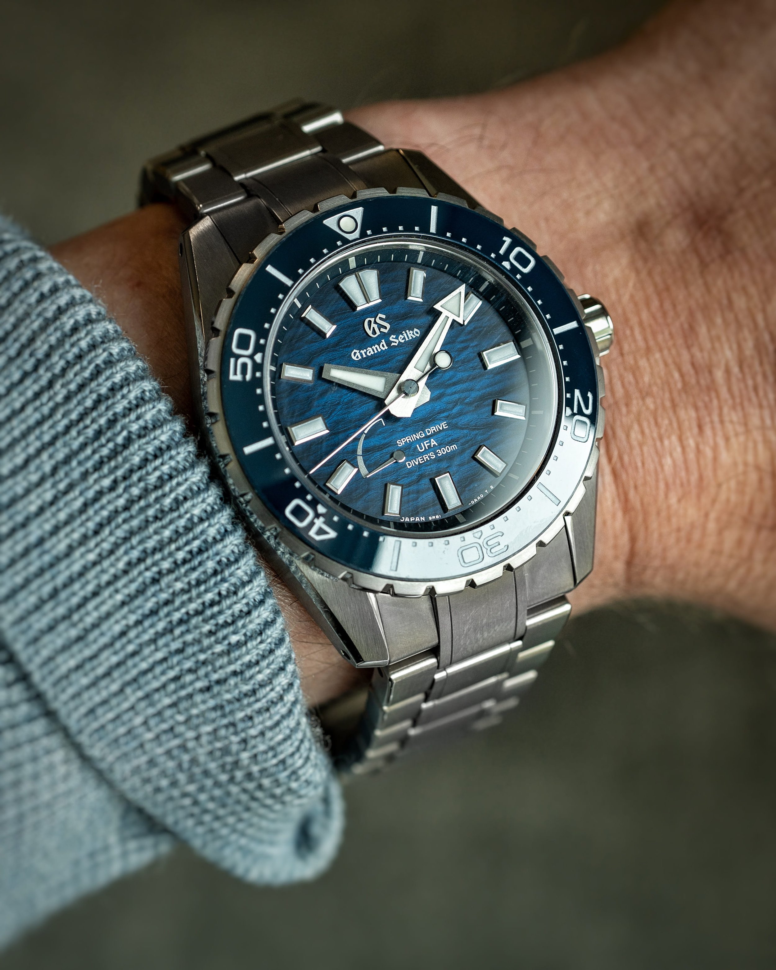 Grand Seiko SLGB023 Ushio 300 Diver on wrist with blue textured dial and titanium bracelet.