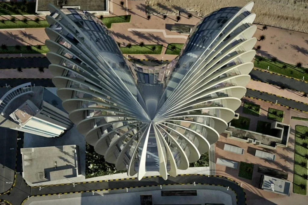 Top-down view of a futuristic high-rise building with a petal-like design, surrounded by pathways and landscaping.