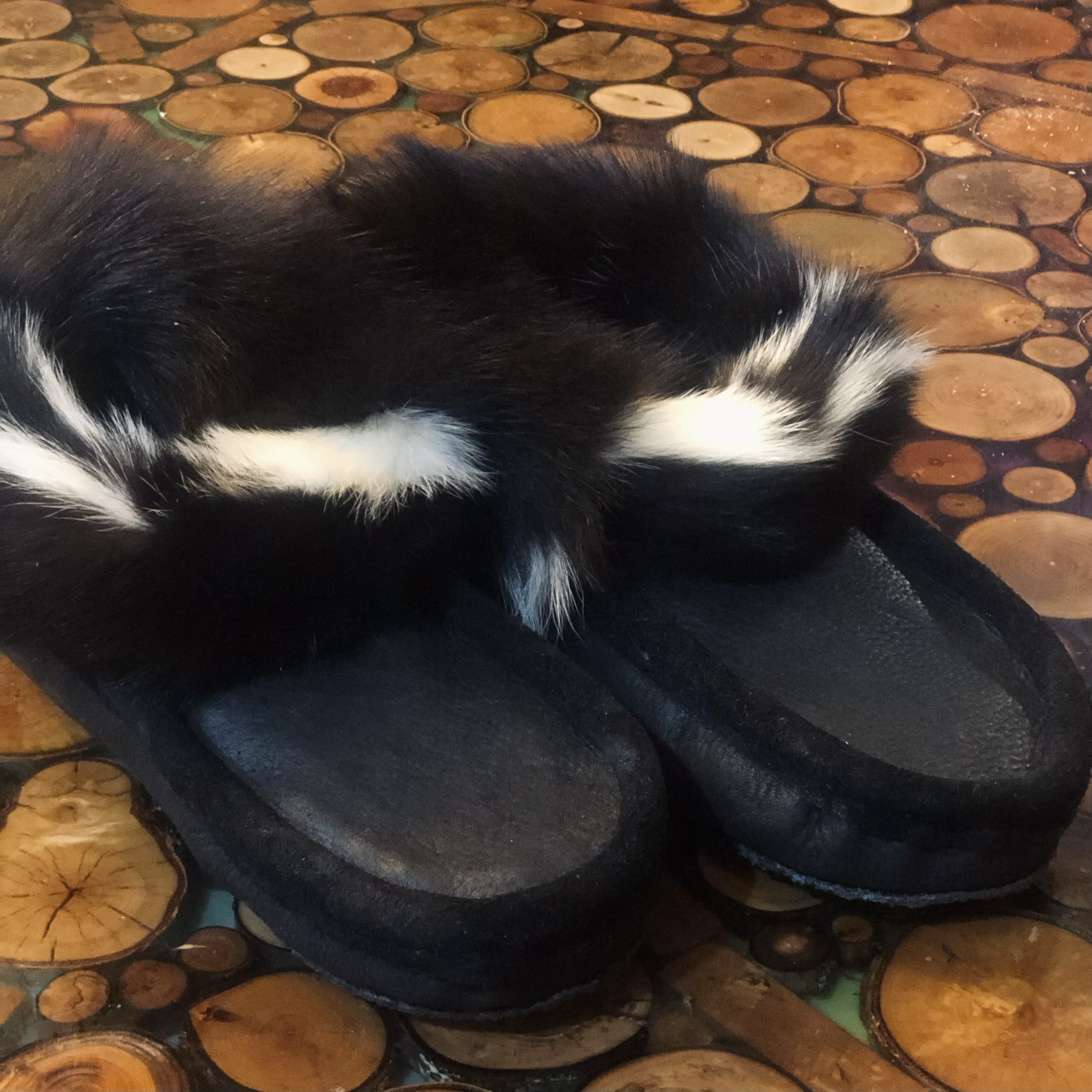 Winter moccasins, black moose-hide, sheepskin lined, skunk fur trim, rubber sole