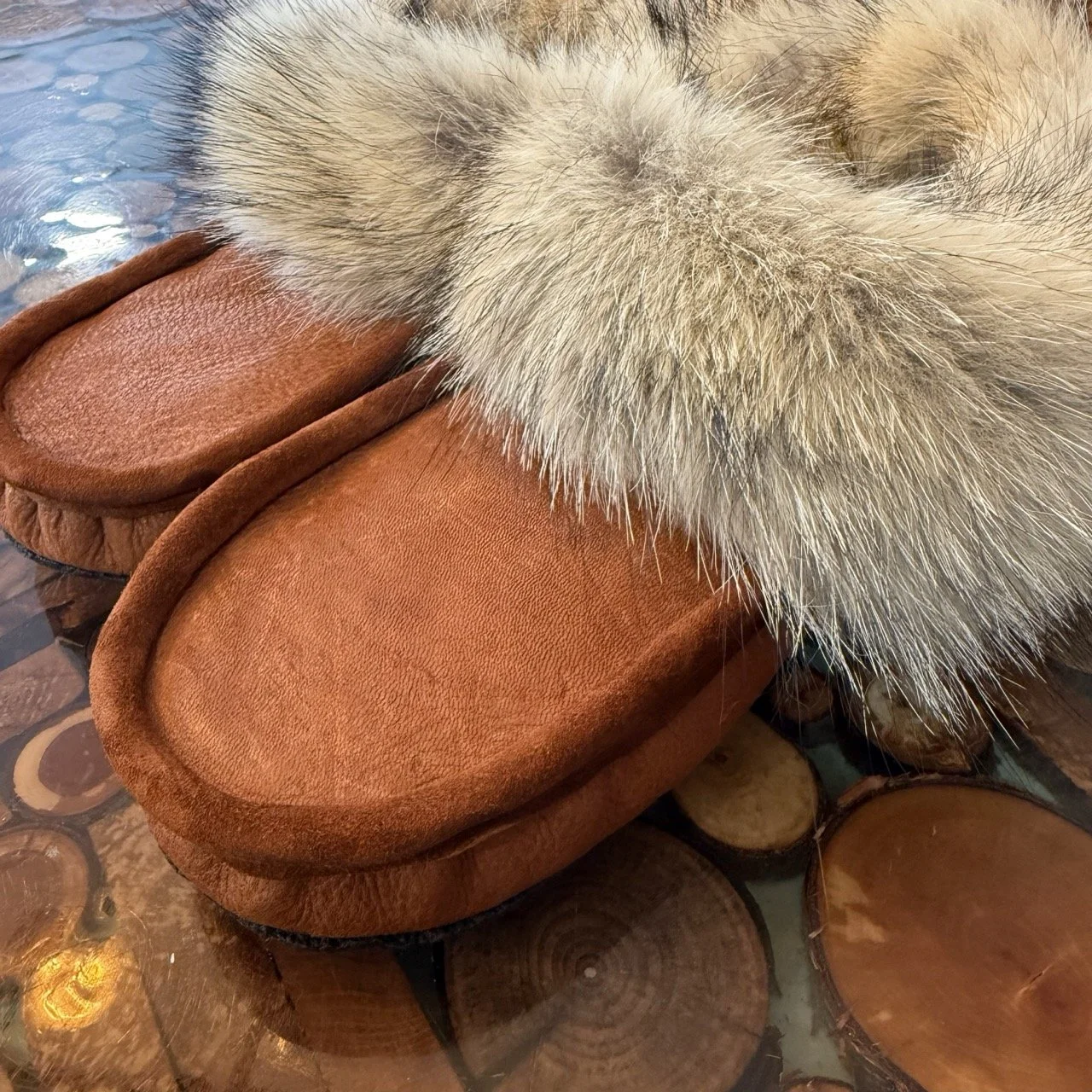 Winter moccasins, brown smooth moosehide leather, sheepskin liner, coyote fur trim, rubber sole