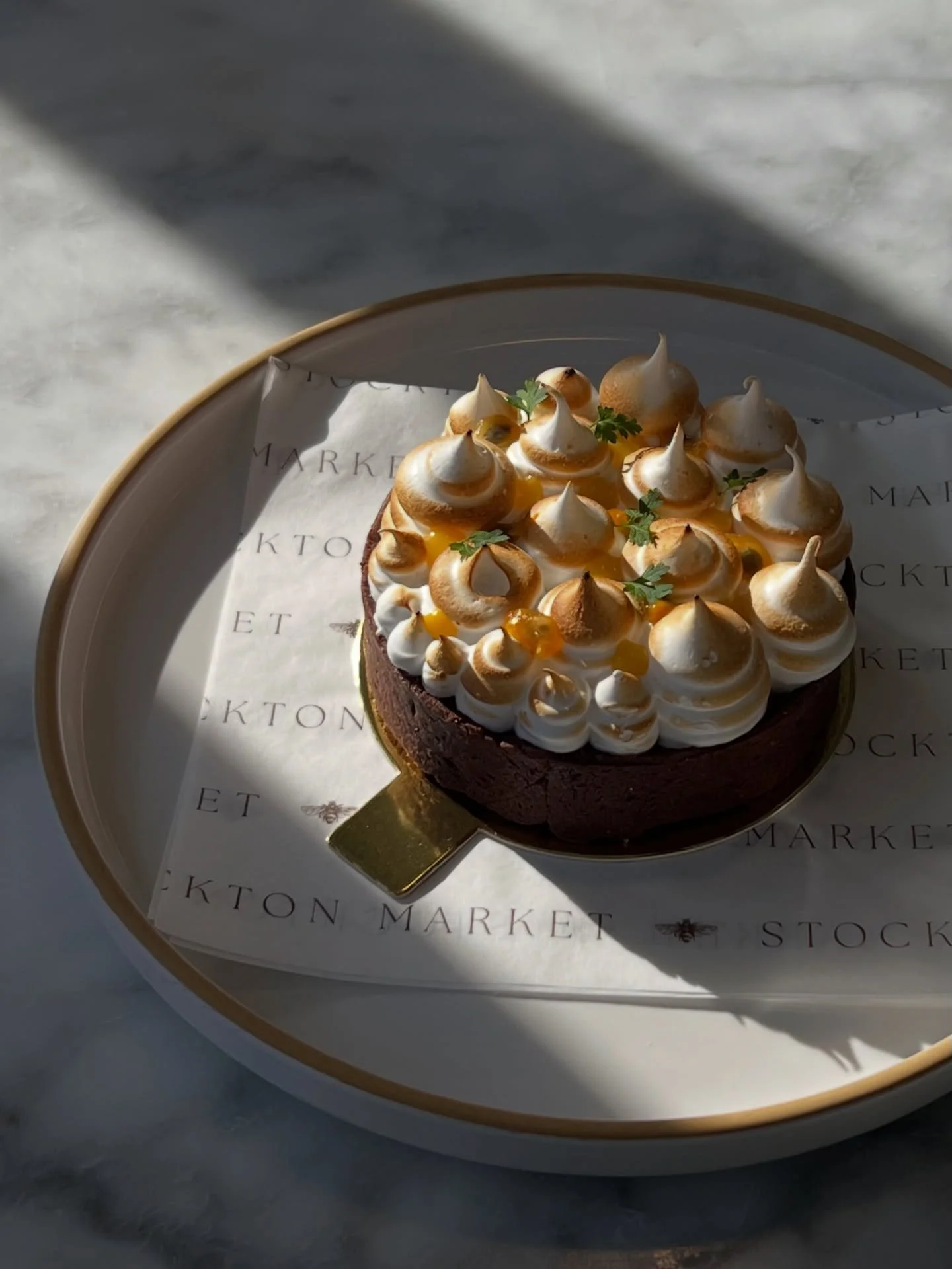 Passion fruit tarts 🌟 chocolate tart crust, filled with tangy passion fruit curd, and topped with a light and sweet meringue! Available now 🤍